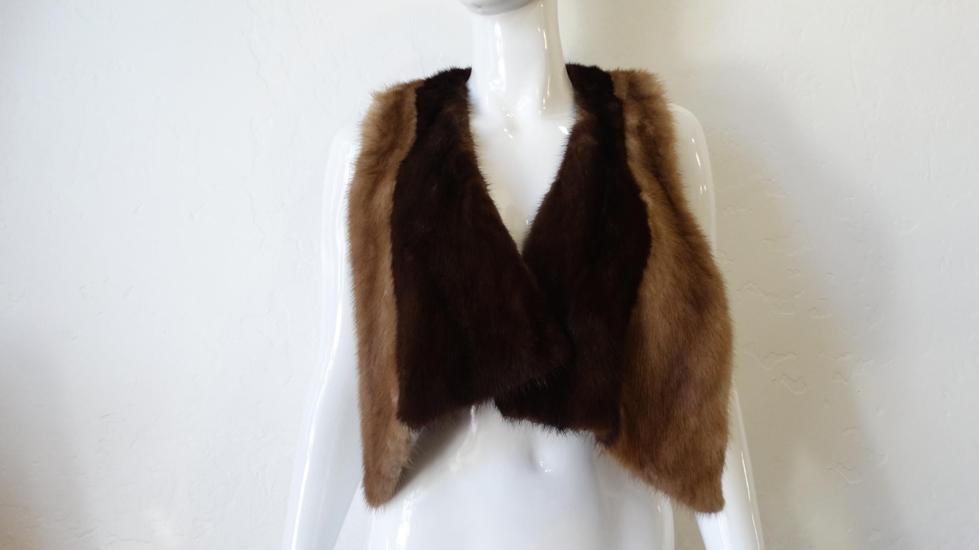 A True Chic And Classic Piece! Circa 1950s, this gorgeous scarf by Hubert de Givenchy is made of two-tone mink fur. This piece features a front hook closure and a top slit, allowing the wearer to wear this piece in multiple ways! The front hem falls