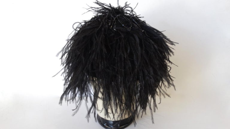 The Most Adorable Beanie Is Here! Designed by Giorgio Armani, this beanie is made with black ostrich feathers and decorated at the top with beaded strands. Perfect to throw on during the fall/winter seasons as an accent piece! Actual beanie is