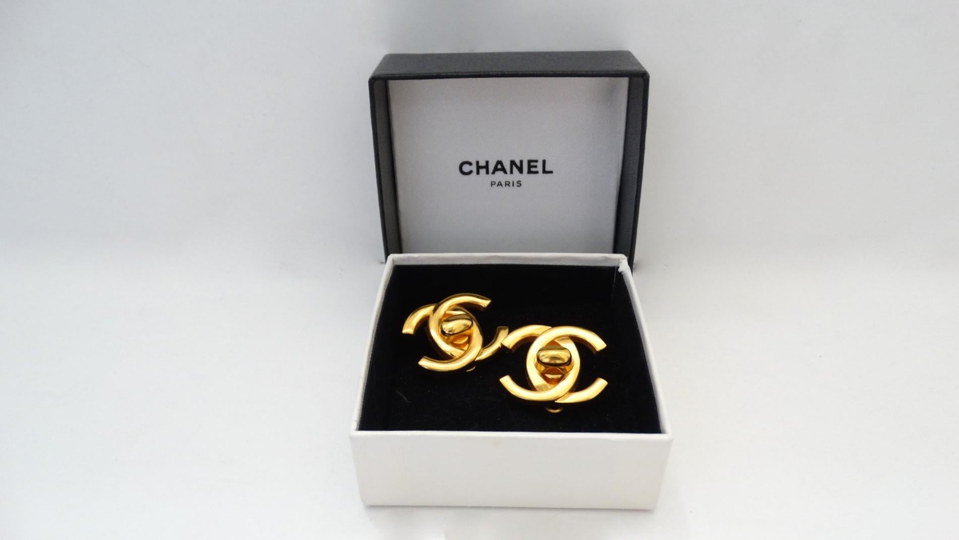 The Cutest Chanel Earrings Are Here! Circa 1995, these gold plated earrings are from Chanel's Fall collection and are in the shape of the signature CC Mademoiselle turn locks featured on Chanel bags. Feature a clip-on closure, come with original box