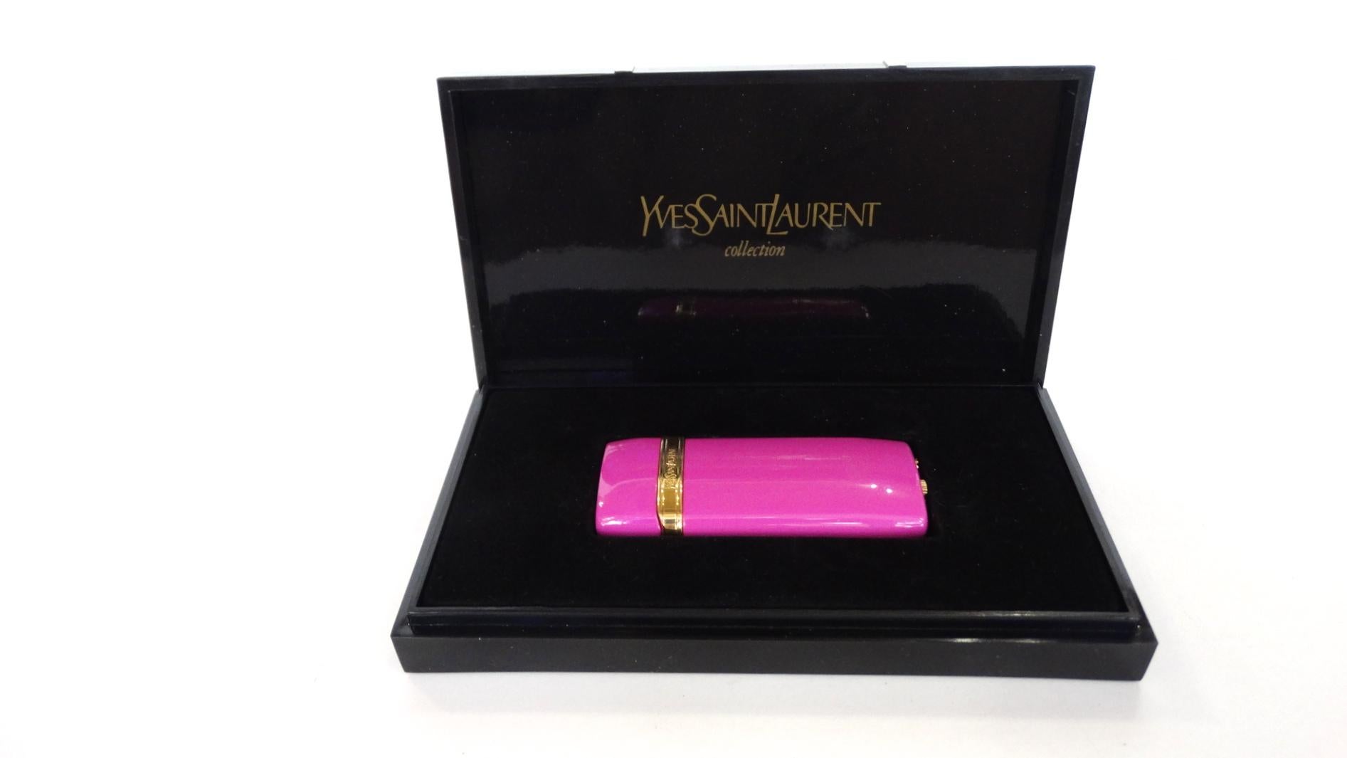 The Most Adorable Novelty Item Is Here! Created by Saint Laurent, this rare 60s Mini Louisiane lighter is hot pink and features gold plated hardware. Gold band is inscribed with 