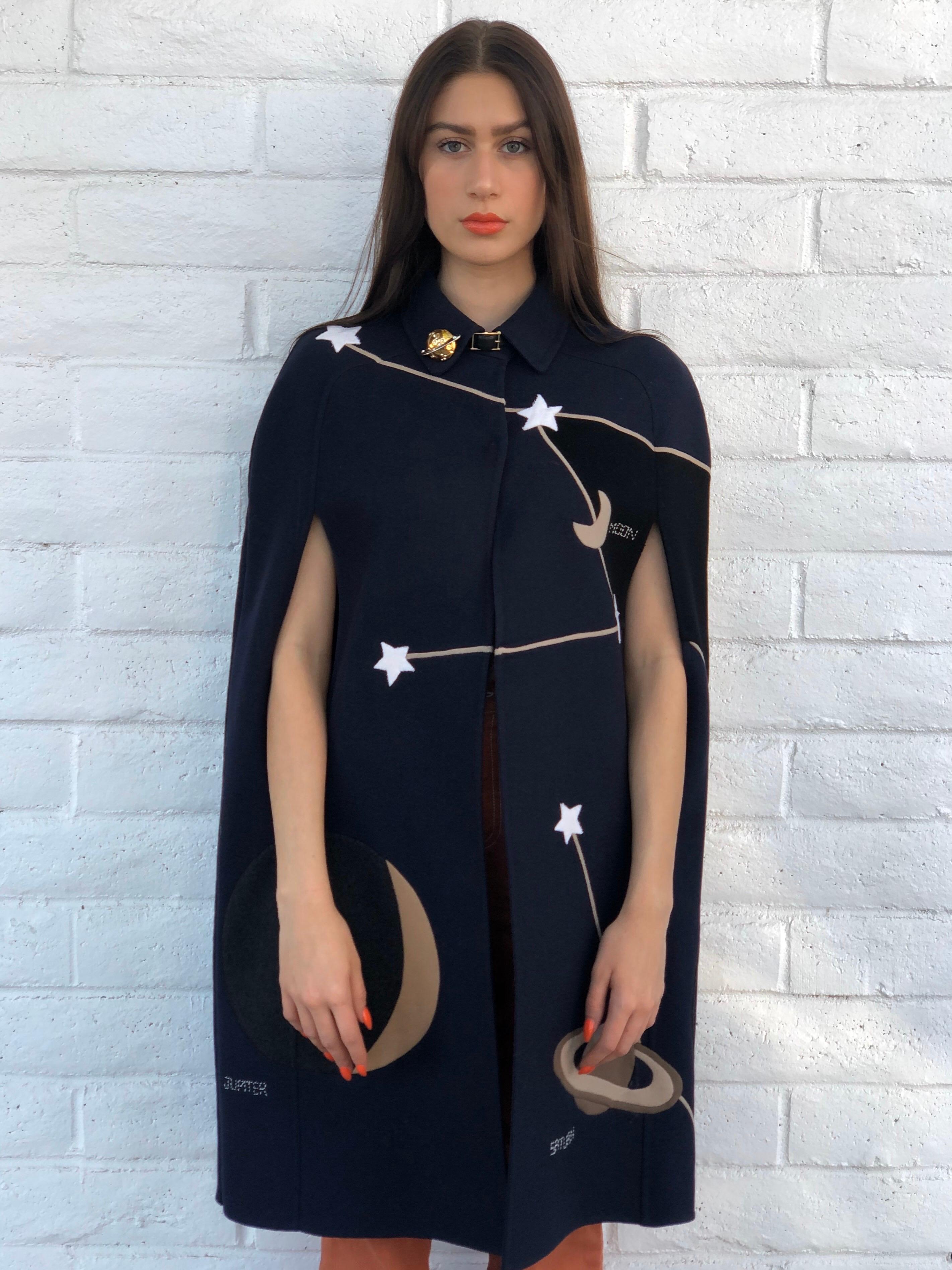 Make all your wishes come true with this Valentino cape! Circa 2015 from their pre-fall collection, this cape is made of deep navy blue wool and features an amazing constellation pattern, hidden front fastenings and a mini leather belt closure at
