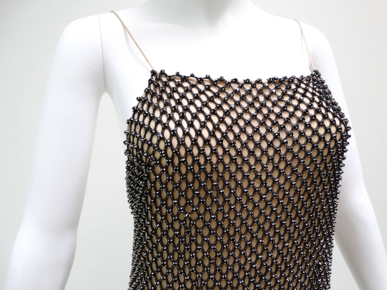 2006 Gucci Black Rhinestone Evening Gown with a Deep Scoop Back… This dress is covered in black rhinestones with a intriquit weave pattern. It has fine spaghetti straps, which are reinforced with double stitch attached to a fully lined silk chiffon