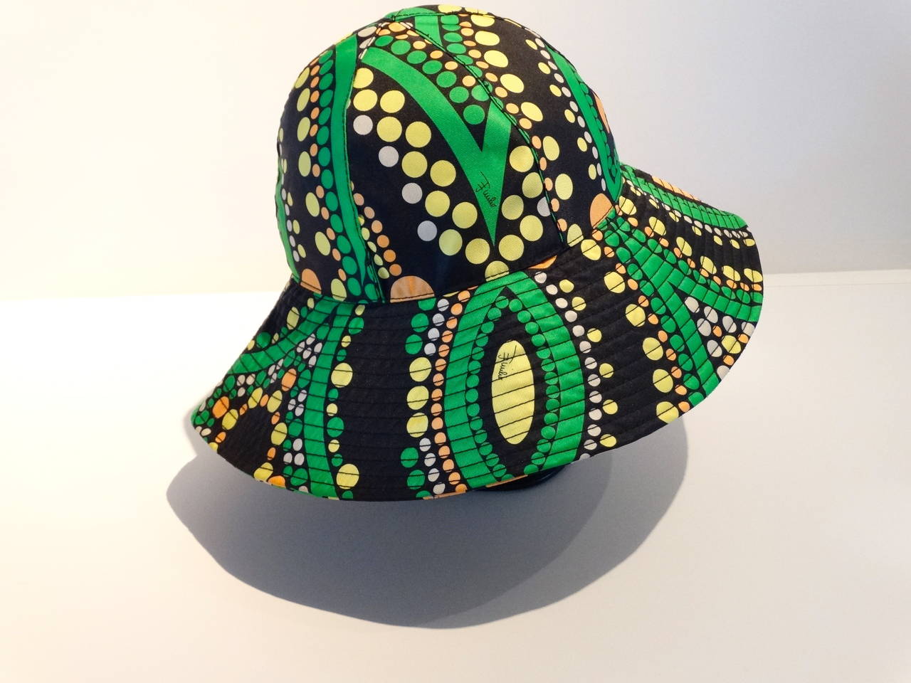 Early 21st century Wide-brimmed sun hat, iconic Pucci print. 
Made in Italy. Style number 77GF01 labeled sz II 
Bright colours in the mod geometric designs of black, green, orange, white and yellow. 

Measurements are:
21 3/4