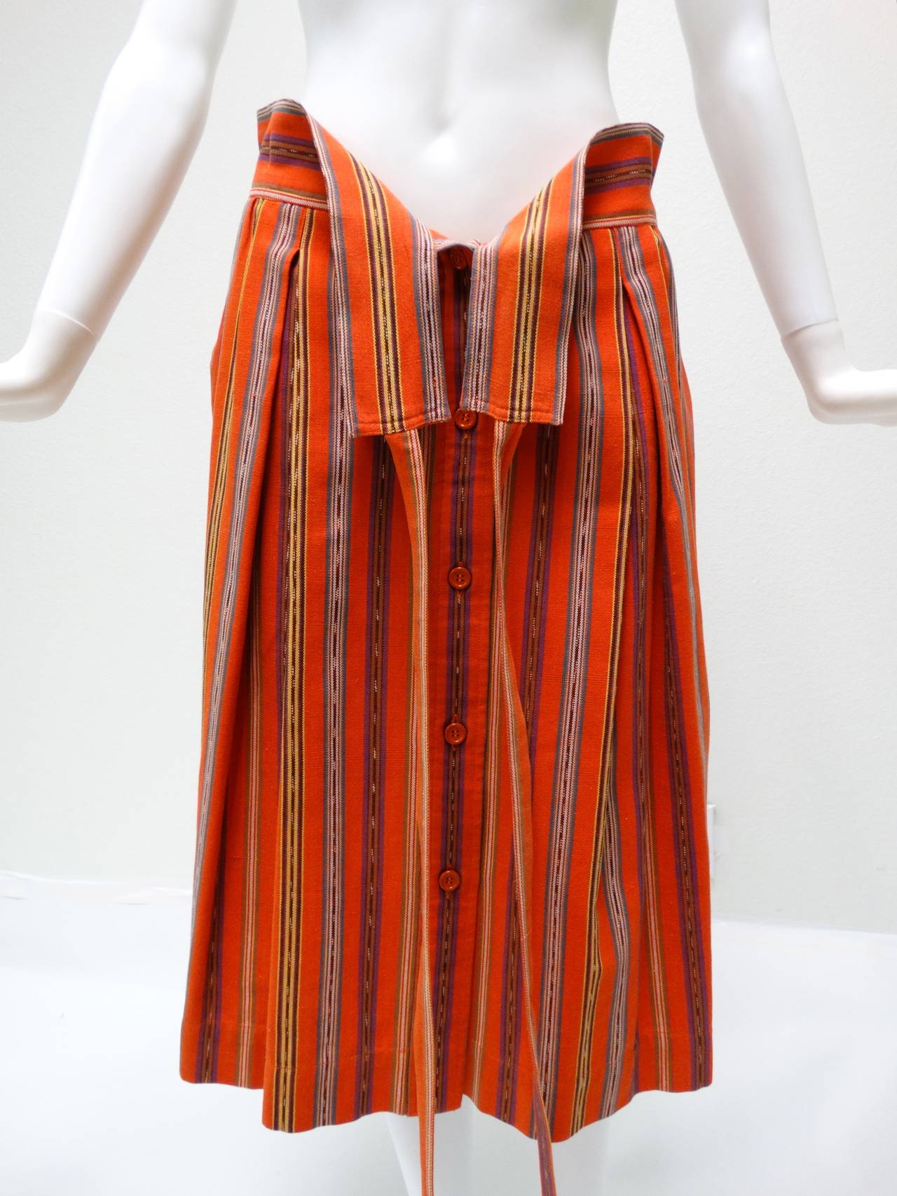 Beautiful rare Saint Laurent 1980's Ethnic Striped Cotton Skirt with an attached Wrap Belt. This lovely buttons down the front and has two pockets on each side. Love the print, it's has a very Saint Laurent Morroccan vibe ! Labeled a size 44, Made