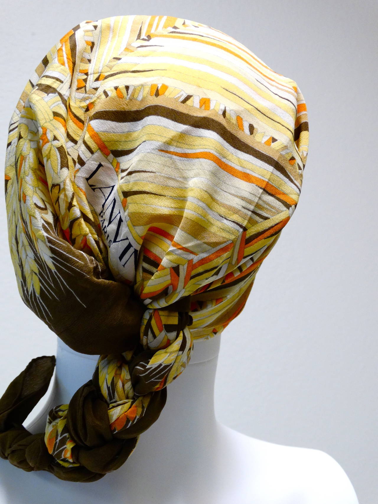 Rare 1970's vintage Lanvin silk scarf with wheat and diamond pattern motif. 
32 x 32 Hand-Rolled hem. With tag: Colors: browns, golds, orange, white, light yellow. Where this lovely scarf wrapped on your head or tie it on your favorite handbag!
