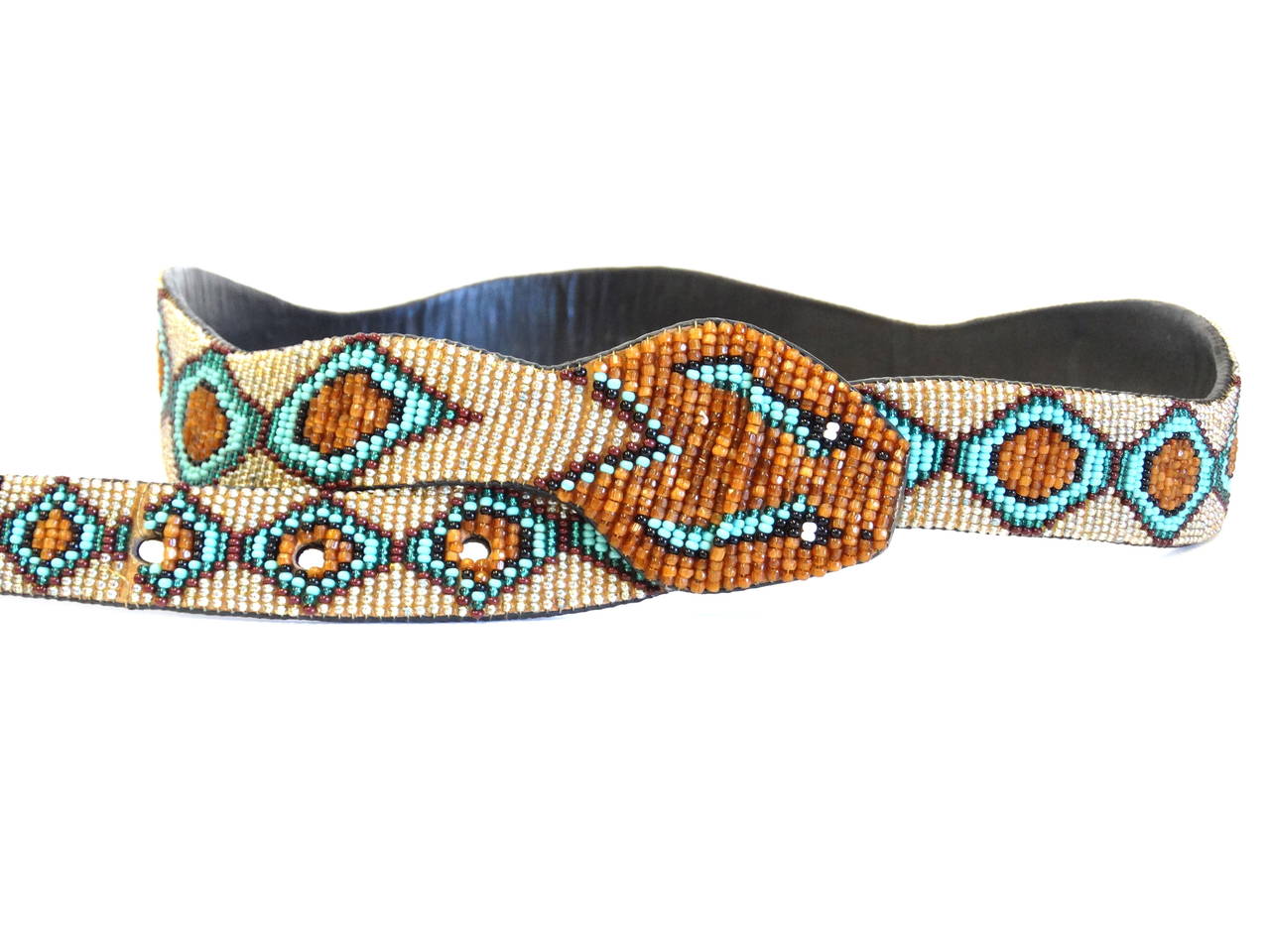 This beautiful 1991 handmade diamondback rattle snake belt is made of small high quality glass beads. Great in color, vibrant turquoise, copper, champagne, black and aqua make this belt into a true one of a kind character piece. Belt is backed with