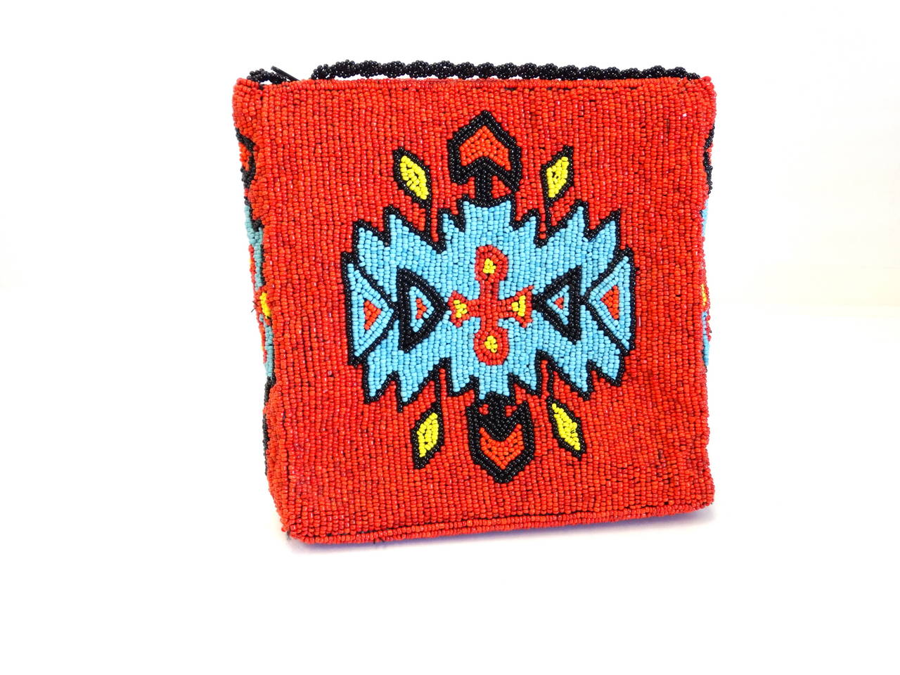 What an exquisite Gammon Shire 1993 beaded southwest motif shoulder bag, great beaded detail on every panel, this beauty has a design even the bottom!
The color palette is of the true southwest! Red, Black, Yellow and Turquoise beads cover this
