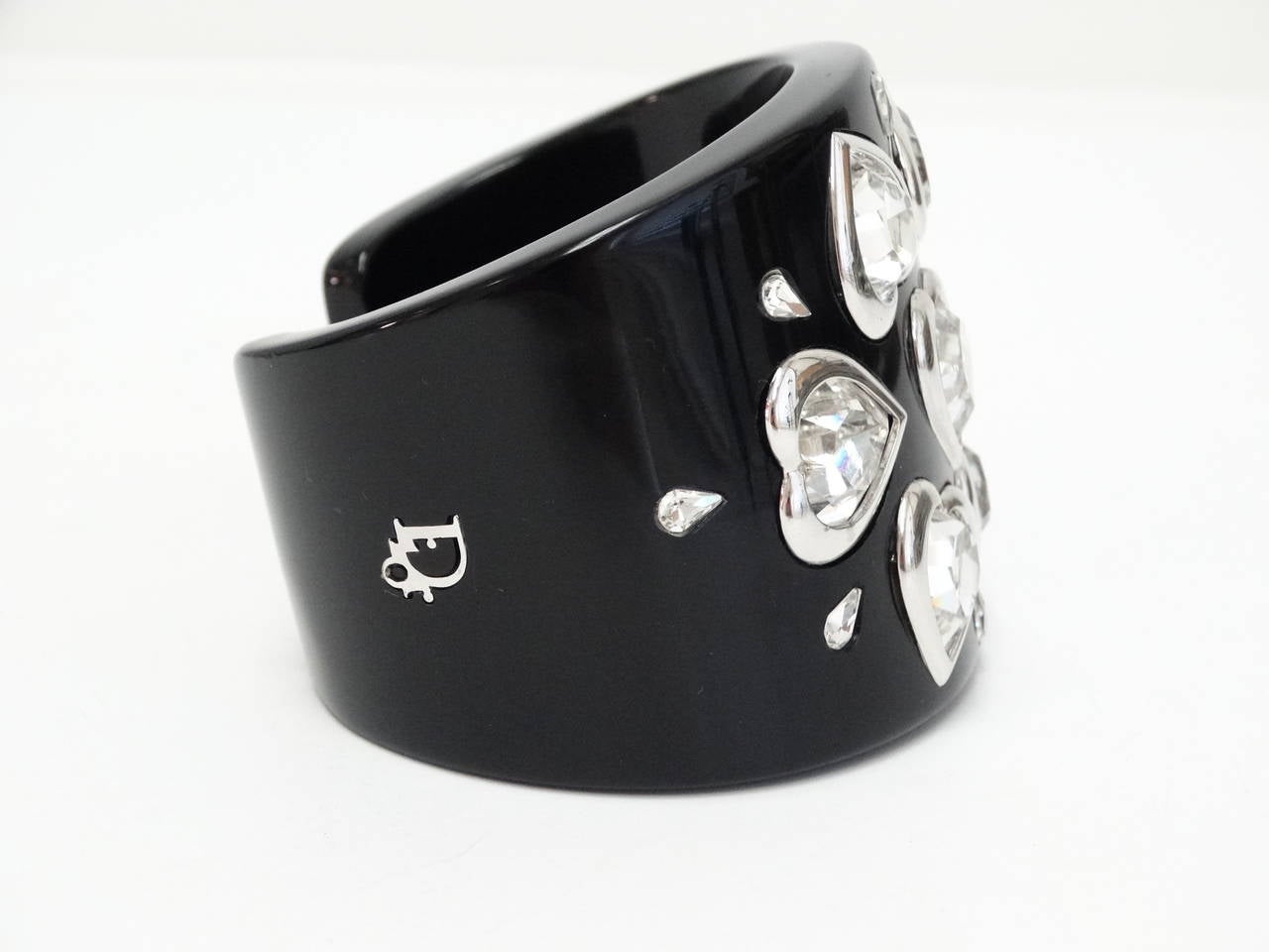 Lovely Dior wide black cuff with amazing heart shape and tear drop rhinestones set in silver tone metal. Glossy thermoset plastic. 
APPROX. SIZE: 2.5 interior diameter, 1