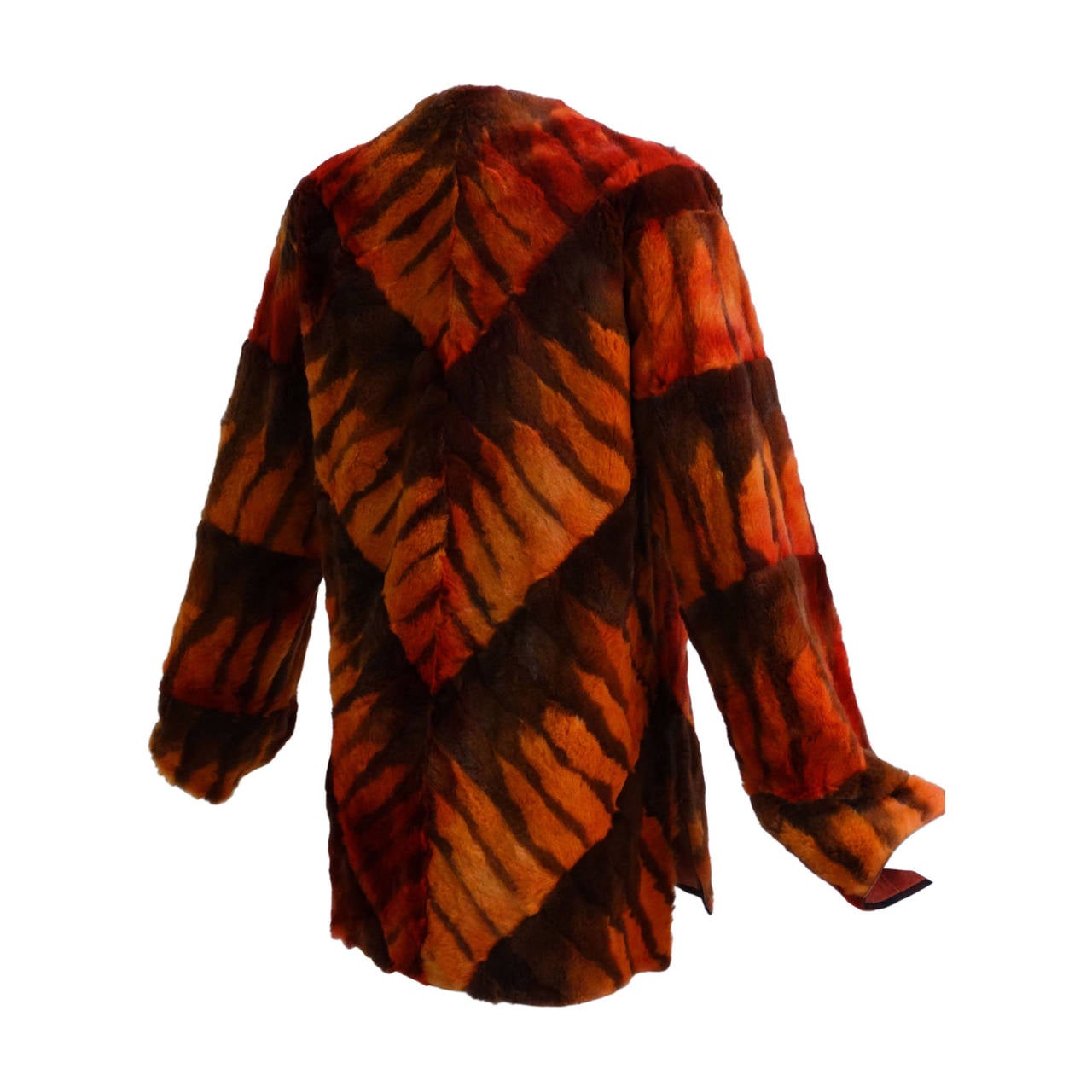 This contemporary piece by Giluliana Teso is truly a unique piece! Fabulous 70's vibe in a funky chevron pattern, colors are a mix of reds, oranges and brown. This piece is a pullover, it does have a side zipper. As seen in Image 6 this piece is