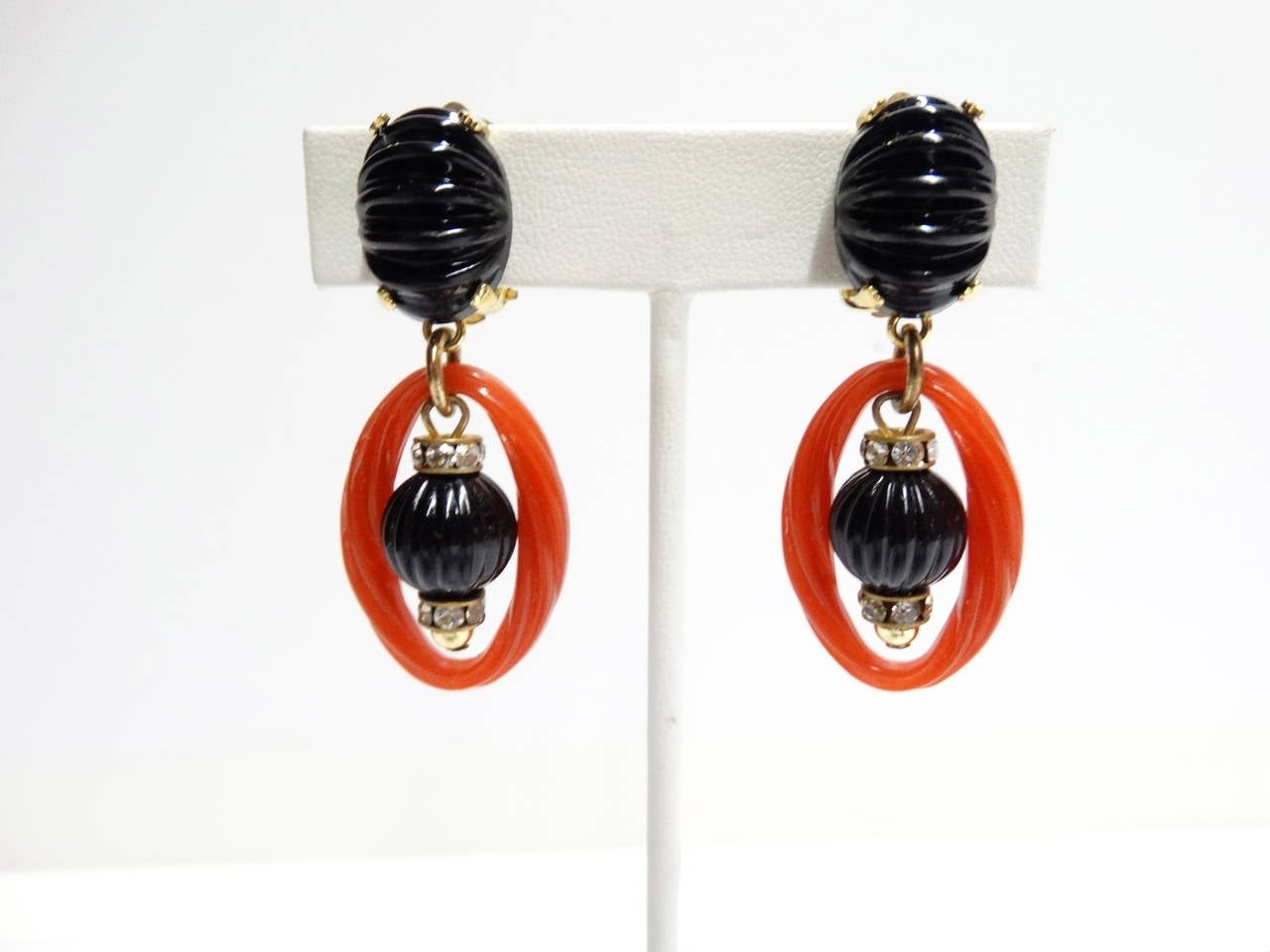 Rare signed 1973 Christian Dior dangle earrings! They feature burt red and jet black resin with a jet black stone in the center of the drop resin hoop. Made in Germany  	

Measurments: 
Lenght:  2 in. 
WIDTH: 2.5 in.