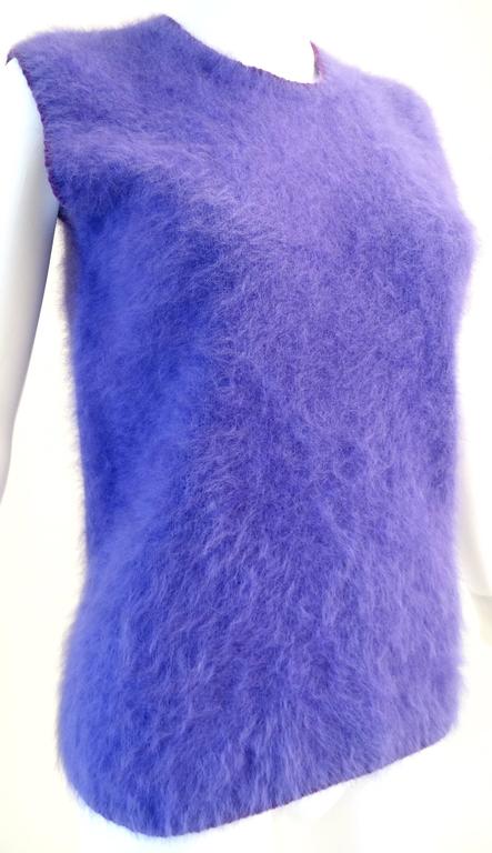 This is a very cozy Angora knit sleeveless sweater from designer Gianni Versace couture circa early 90's. Sweater is in a fabulous purple with a deep purple knit trim around the neck and arm holes. Great for layering! Marked a size 44 (See image #8