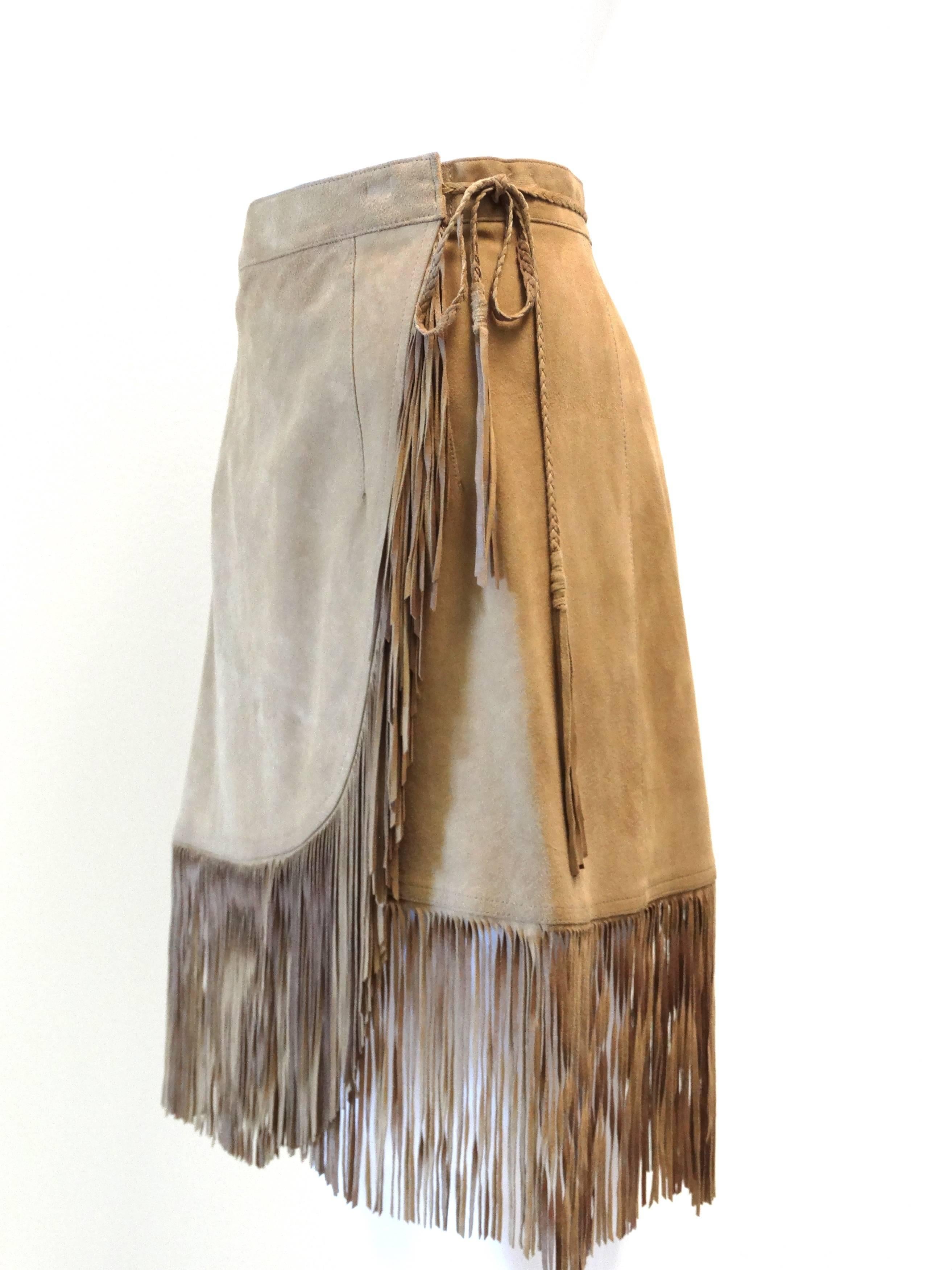 A beautiful fringe skirt designed by Jose'Luis circa 1970's with the softest suede. Skirt wraps around you then as a small hook closure to secure at the side. Also has a small braided tie that wraps around the back to tie at the side. Marked a size