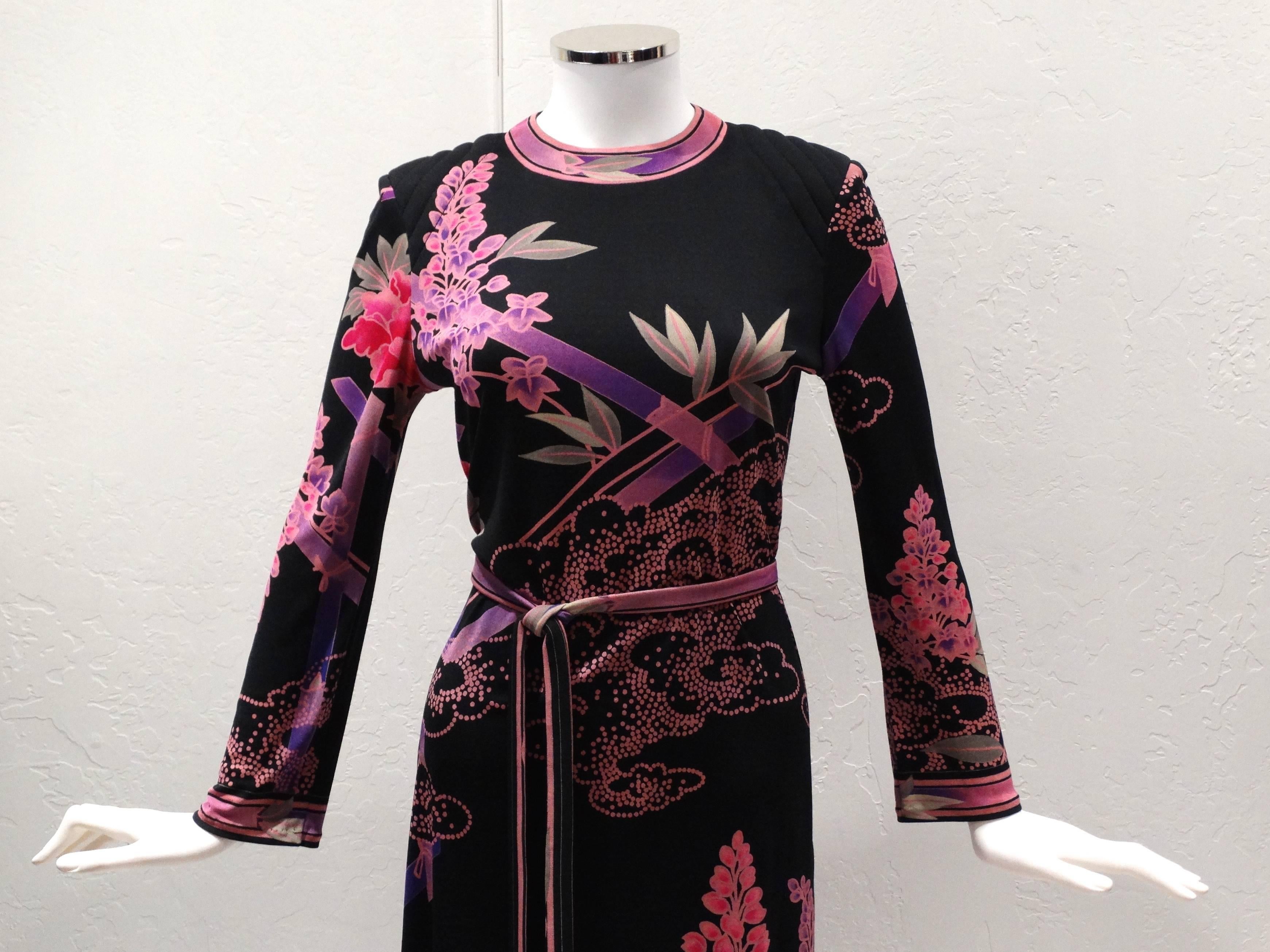 A beautiful 1970s Leonard Asian motif printed dress with matching belt with gold tassels at the end. In pinks, black, gray and purple. The dress is silk jersey featuring a round neck, long sleeves, a belted waist and a mid-length. Signed Leonard on