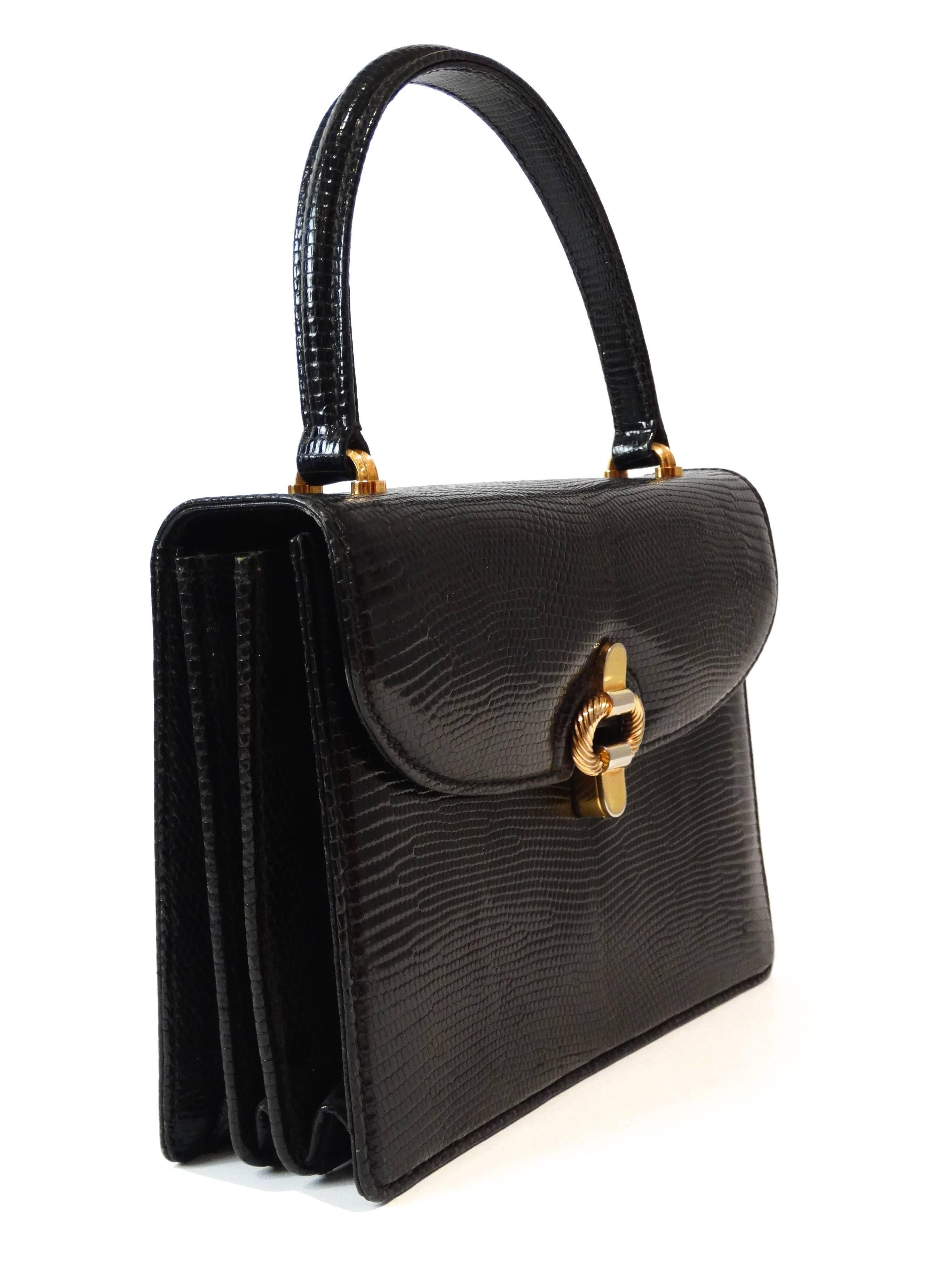 Rare...Jet black lizard box top handle bag with gold hardware designed by Gucci dating to the 1970's. Bag measures 9
