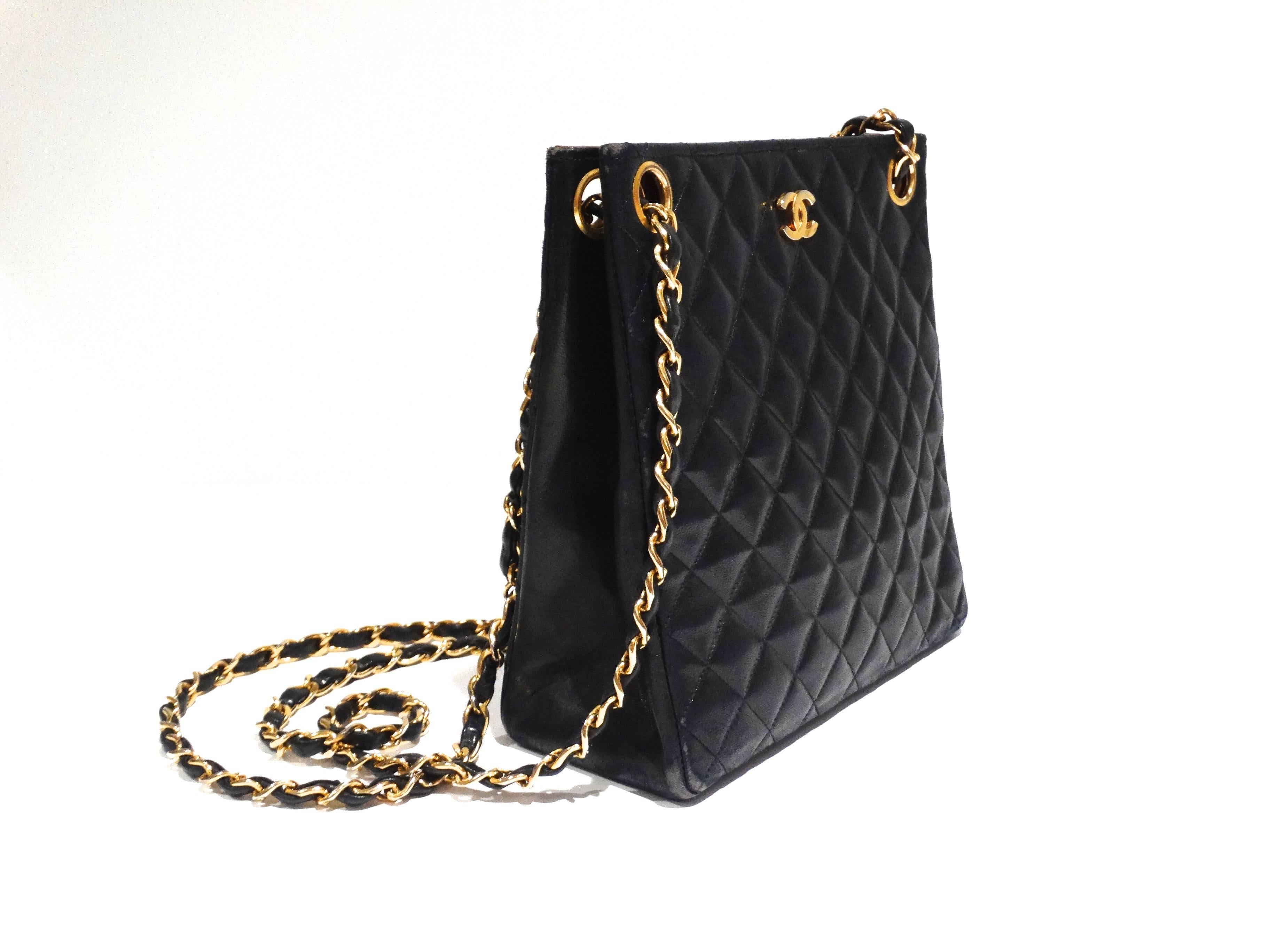 Classic 80's Structured Chanel Shoulder Bag...In a deep navy blue! I love the style of this Chanel bag , it's great for day or evening. Bag features black leather,  diamond quilted detailing,  gold CC logo at front and a gold chain shoulder strap