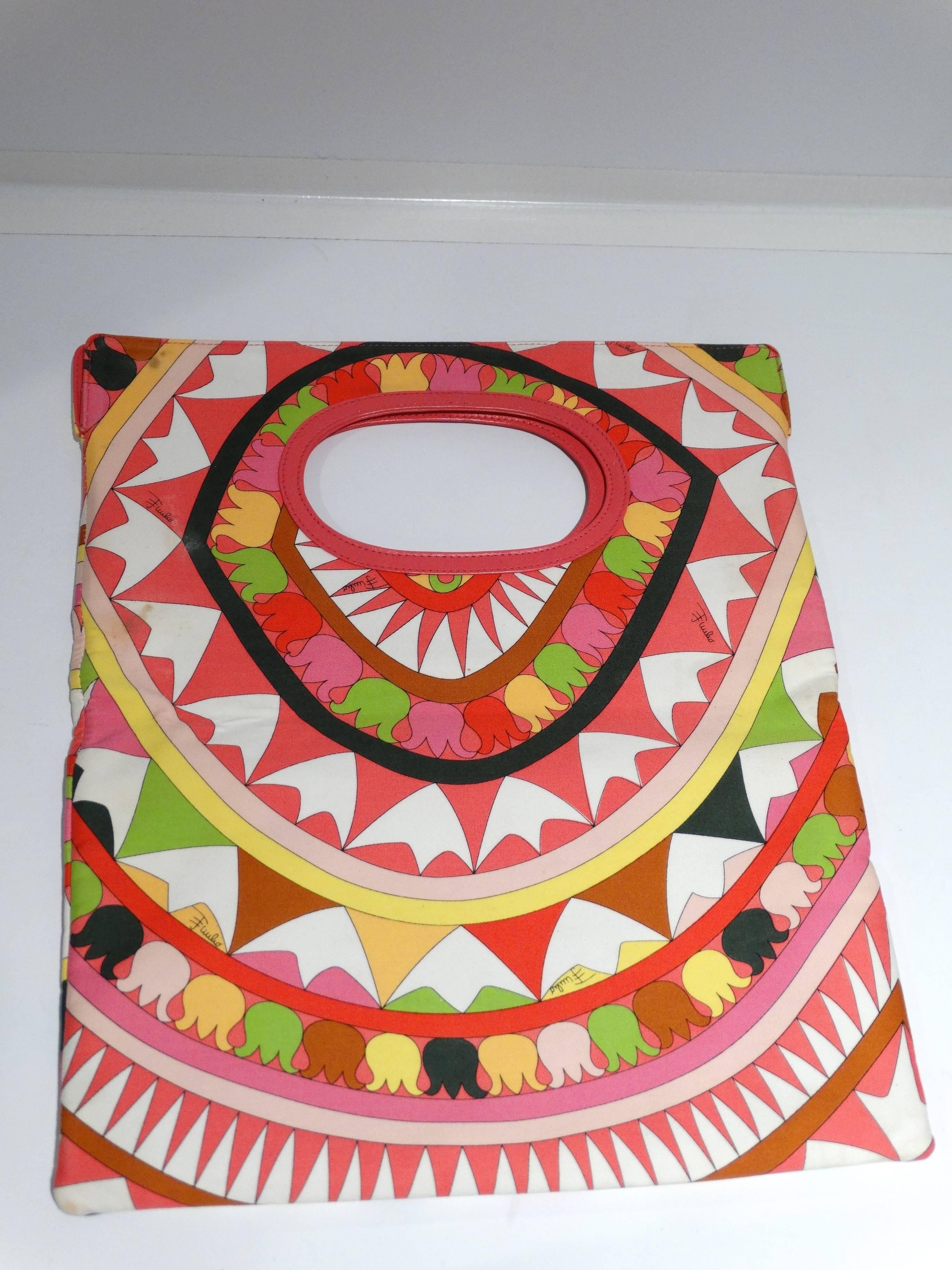 Early 90's Pink and multicolor canvas print Emilio Pucci fold-over clutch with pink leather trim throughout, black woven lining with signature pucci lining, single pocket at interior wall. Magnetic closure at top. 

Measurements:
Handle Drop