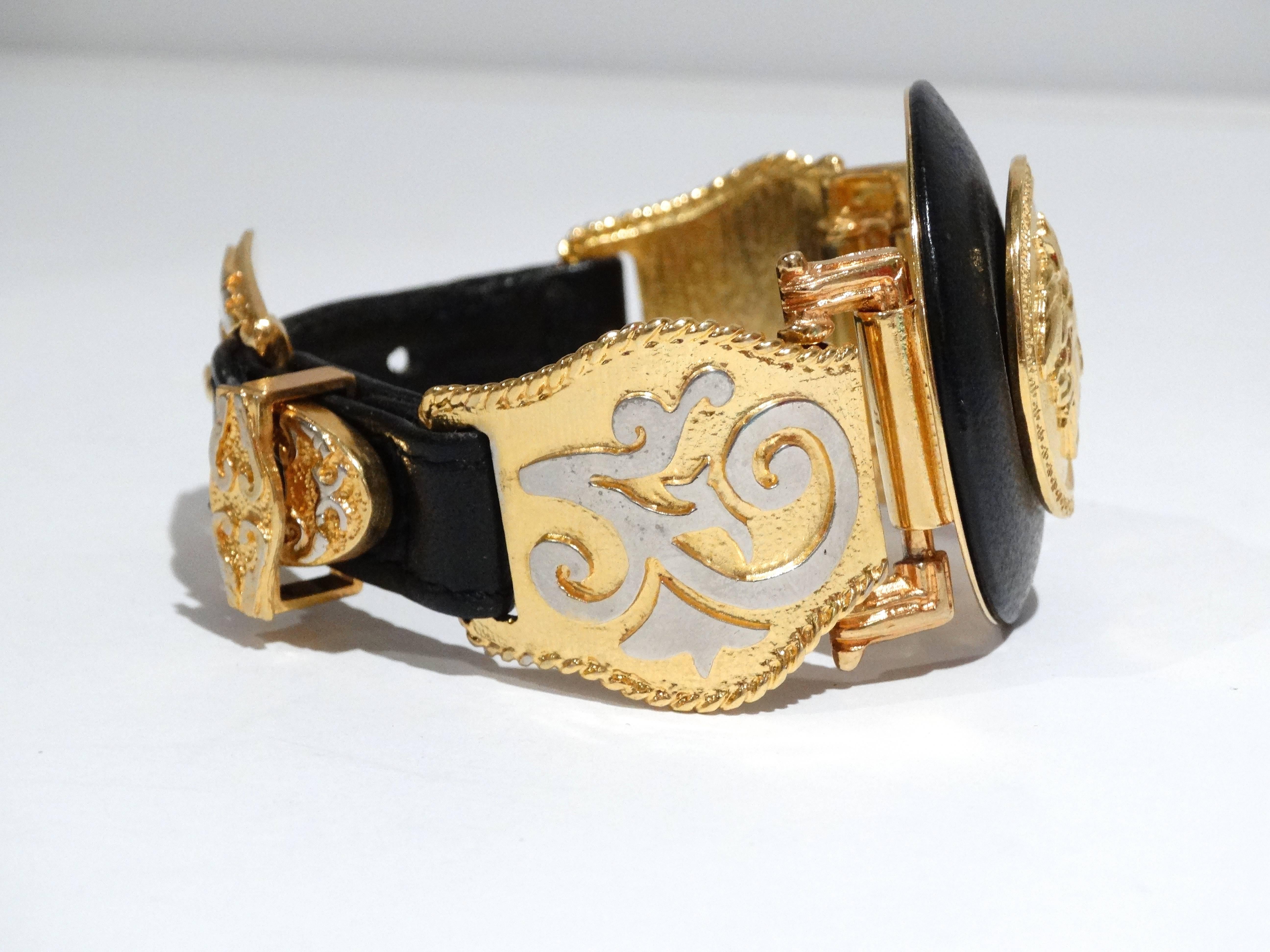 This 1990's Gianni Versace Iconic Medusa buckle bracelet is a RARE piece. Featuring a large Medusa Medallion with black leather trim. Gold plated side hardware with a leather buckle closure. A true treasure for Versace collectors. Original designed