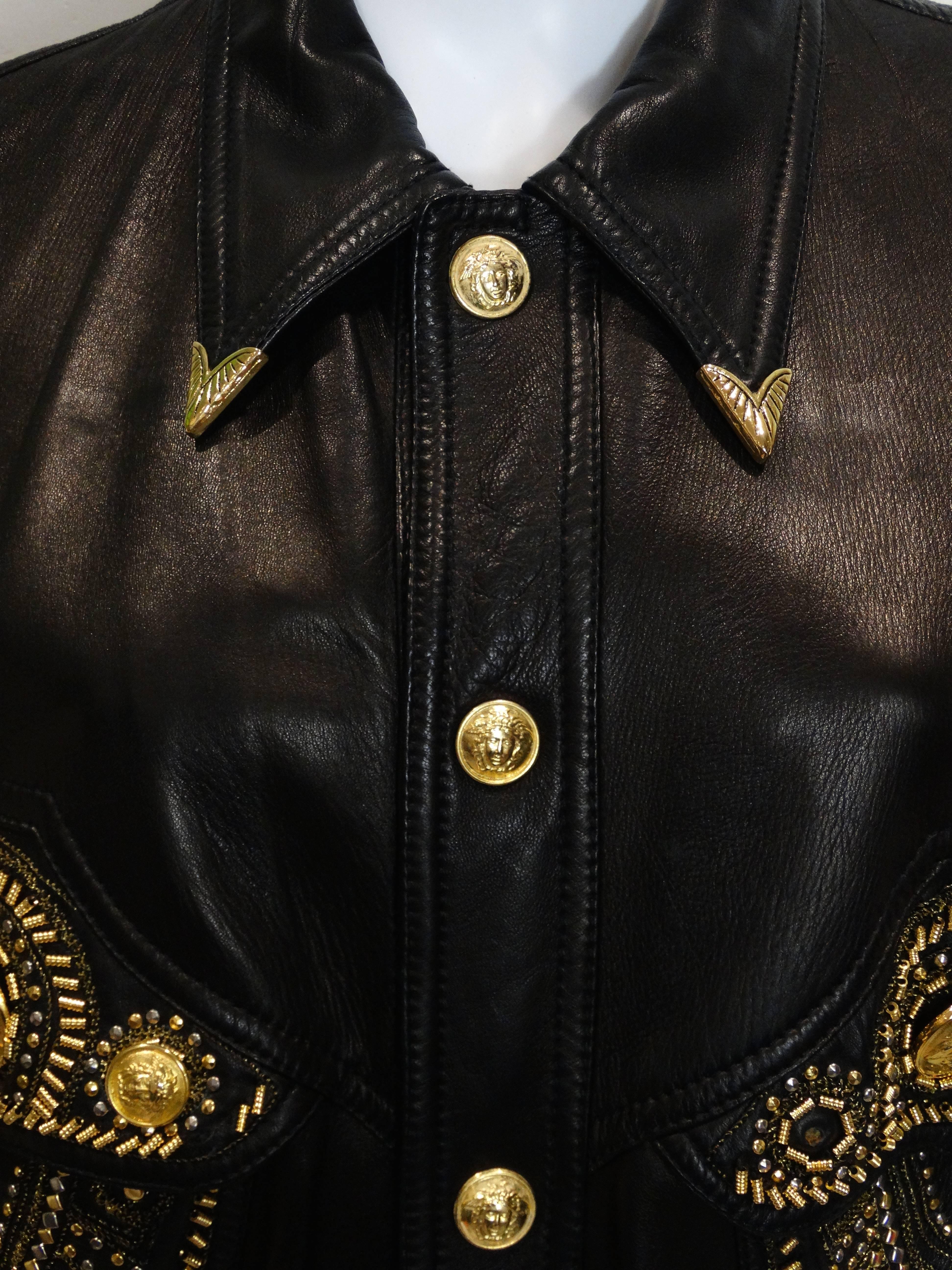 This iconic 1990's cropped black-leather motor cycle jacket is a wonderful example of Gianni Versace's genius. Loving the overload of gold and silver -studs and Medusa head buttons which for Versace reflected beauty, art and philosophy. The cropped