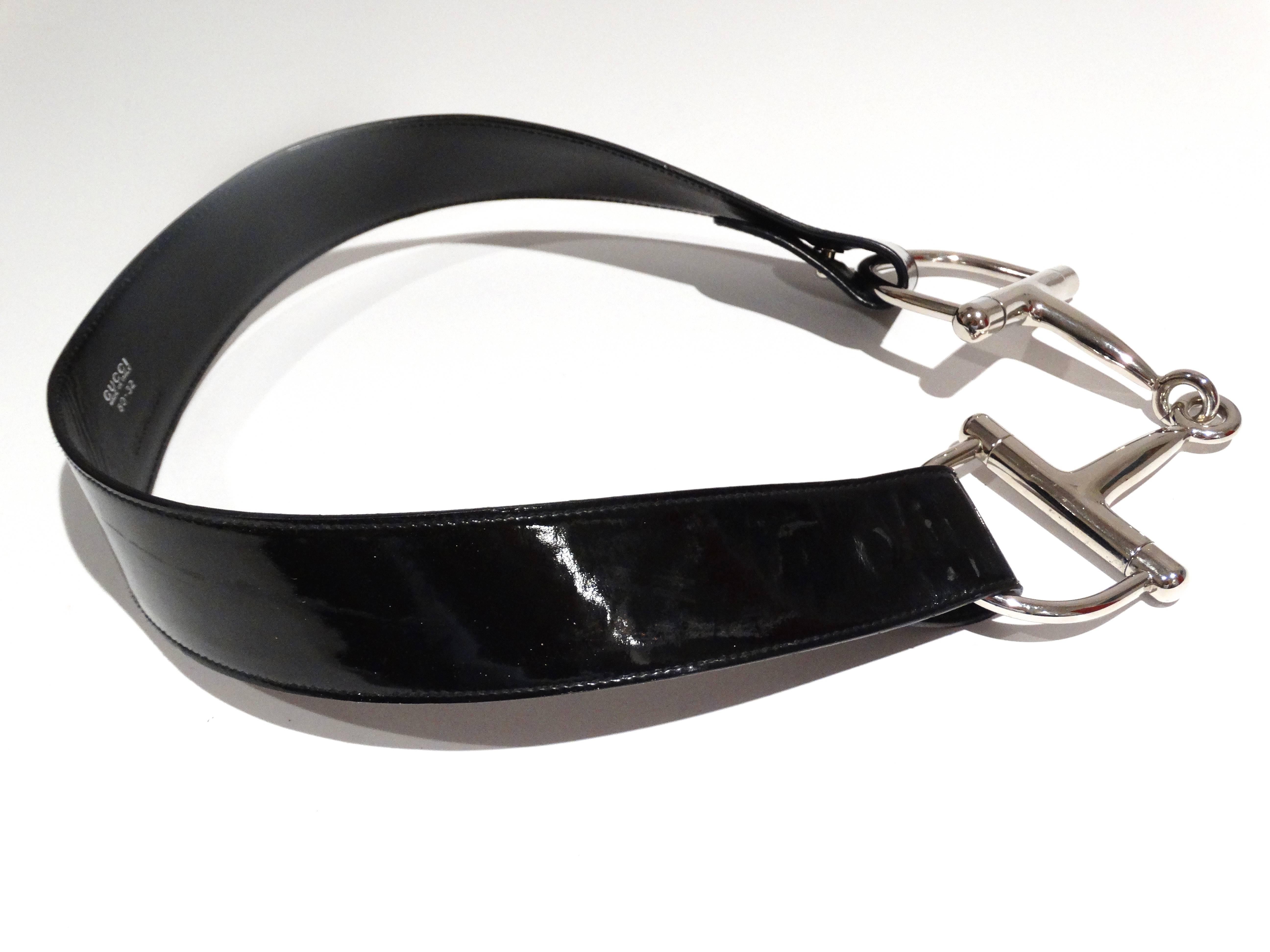 This iconic Gucci stirrup buckle belt in black patent leather is a Gucci and Tom Ford staple. Meant to sit low on hips.  in Excellent condition.  Tom Ford's first collection as seen on Madonna when she won her moon man! 

Measurements 28-32