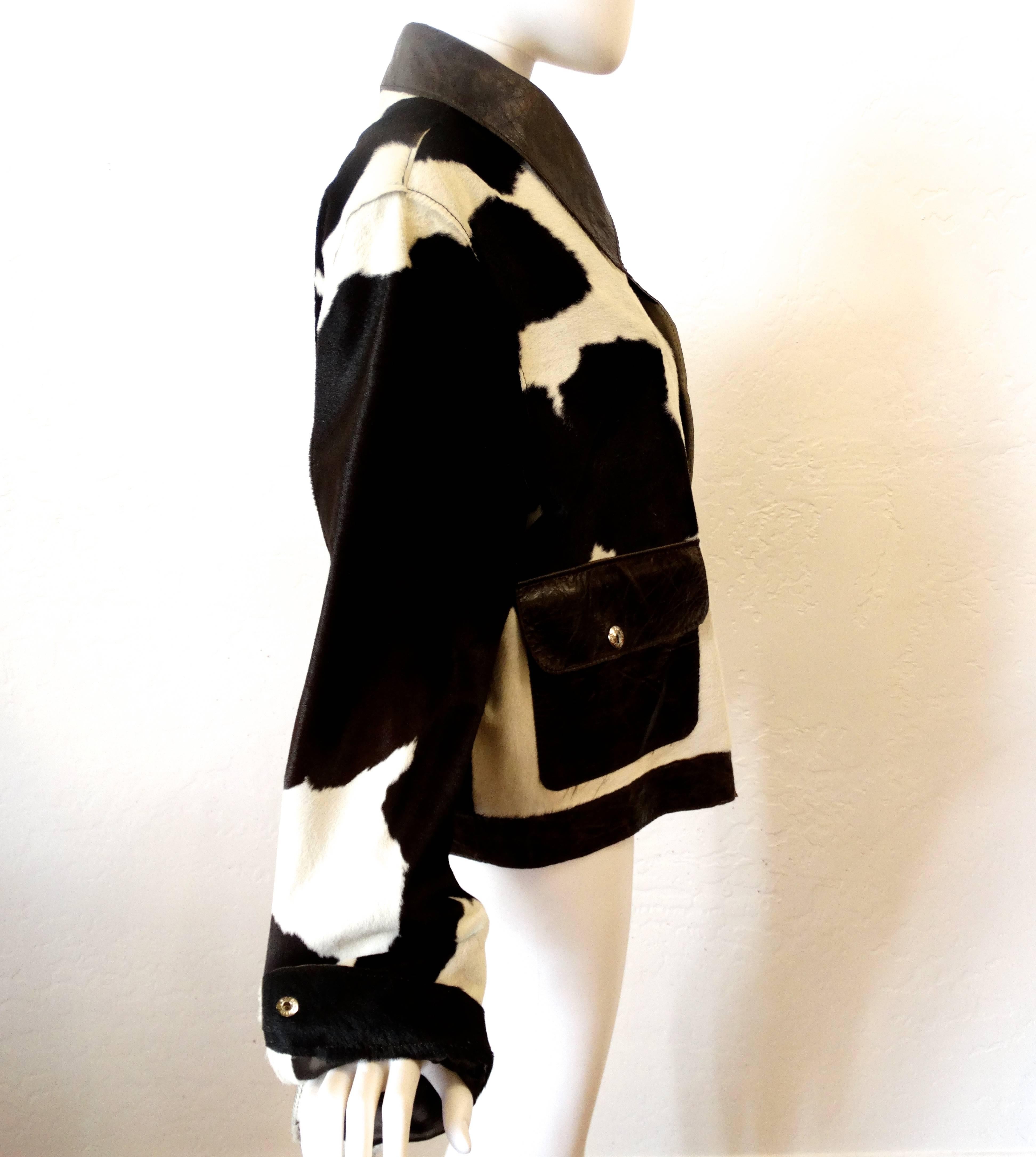 This is a rare early 1990's Dolce & Gabbana Cowhide Jacket in dark chocolate cowhide and white leather cowhide. Chocolate leather trim with silver hardware. Two front leather pockets and large leather collar. Fits size medium to large Made in Italy 