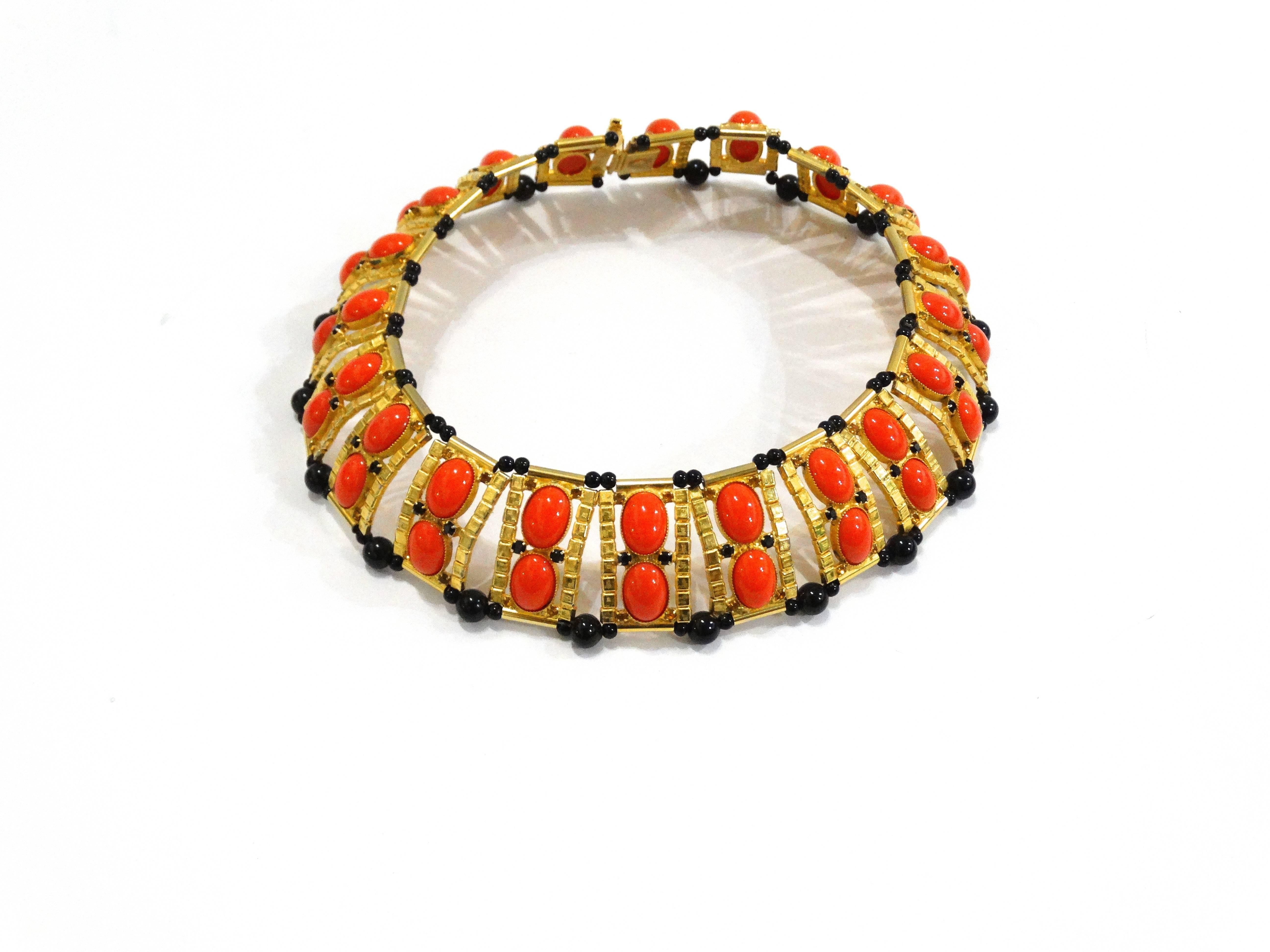 A true master piece designed by William de Lillo for Bishop Monseigneur Joseph Sembel in 1974. This beautiful Egyptian Revival collar necklace is designed with coral cabochons and black onyx beads. Gold plated hardware. This beautiful piece was