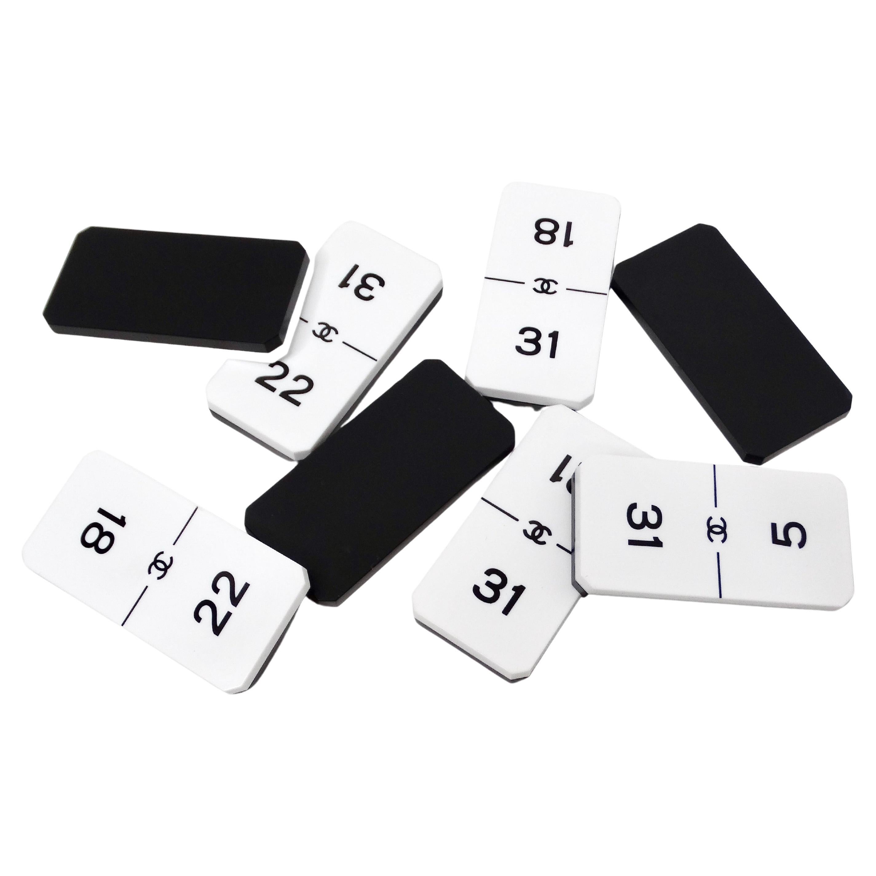 The Chanel White & Black Interlocking CC Collectible Domino Set from circa 2016 is a stylish accessory that embodies the timeless elegance of the Chanel brand. Crafted with meticulous attention to detail, these domino pieces feature the iconic