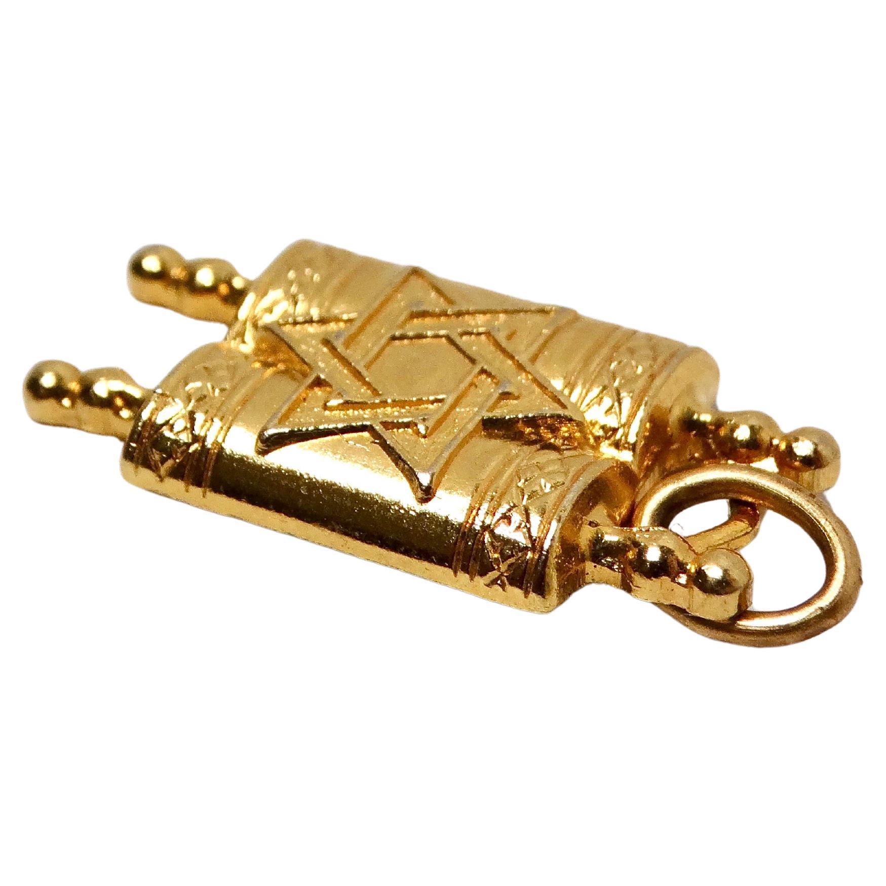 Questo elegante ciondolo della Torah in oro 14k, risalente agli anni '90, incarna un'eleganza spirituale senza tempo. Realizzato con grande attenzione ai dettagli, il ciondolo presenta una delicata rappresentazione del rotolo della Torah, simbolo di