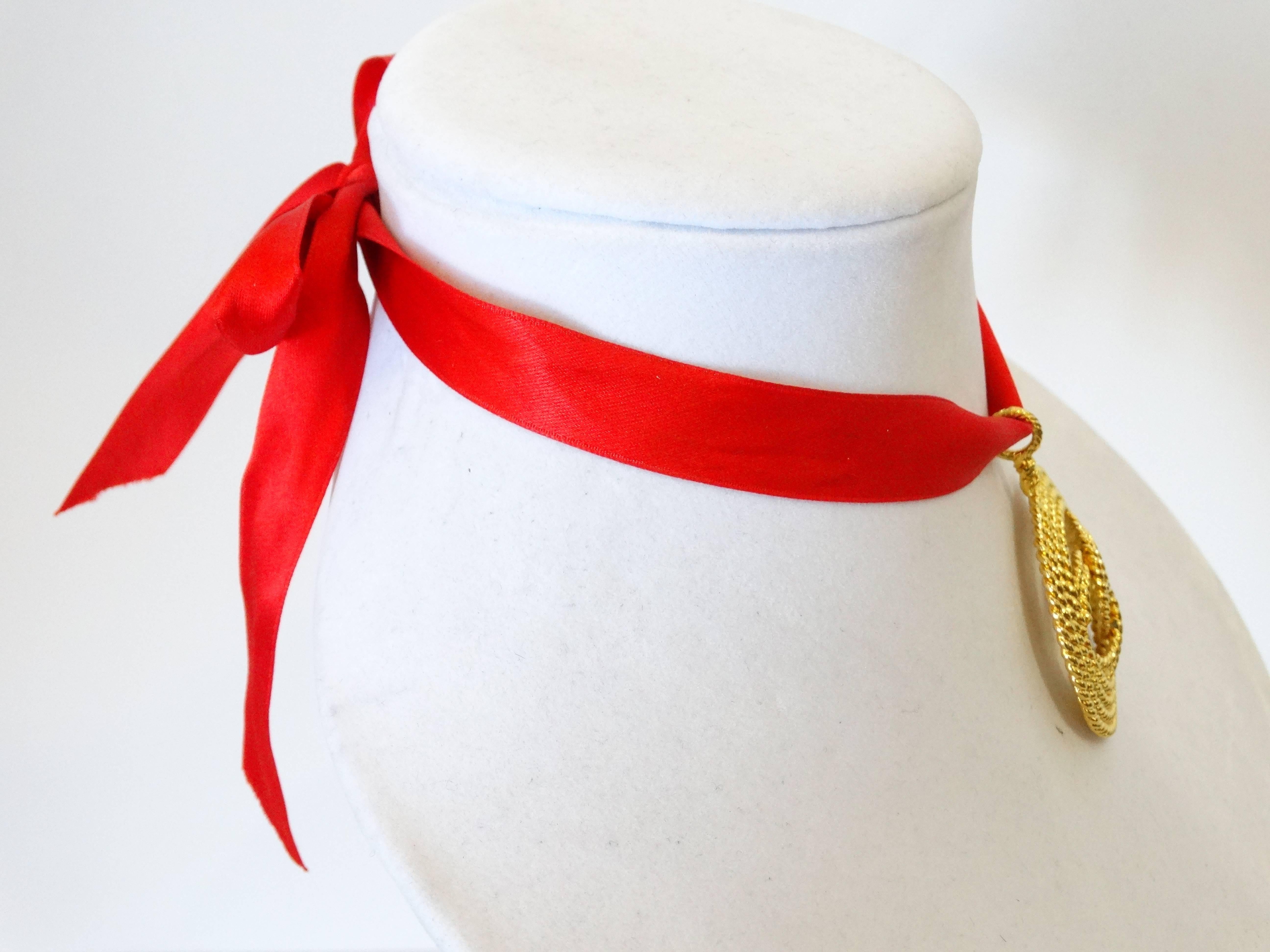 A classic pendent necklace worn as a chocker designed by Karl Lagerfeld for Chanel. Large plated gold medallion with large center CC, pendent is in a rope design. Chanel Made in France signed 2 8 red silk ribbon was added. You can request any color