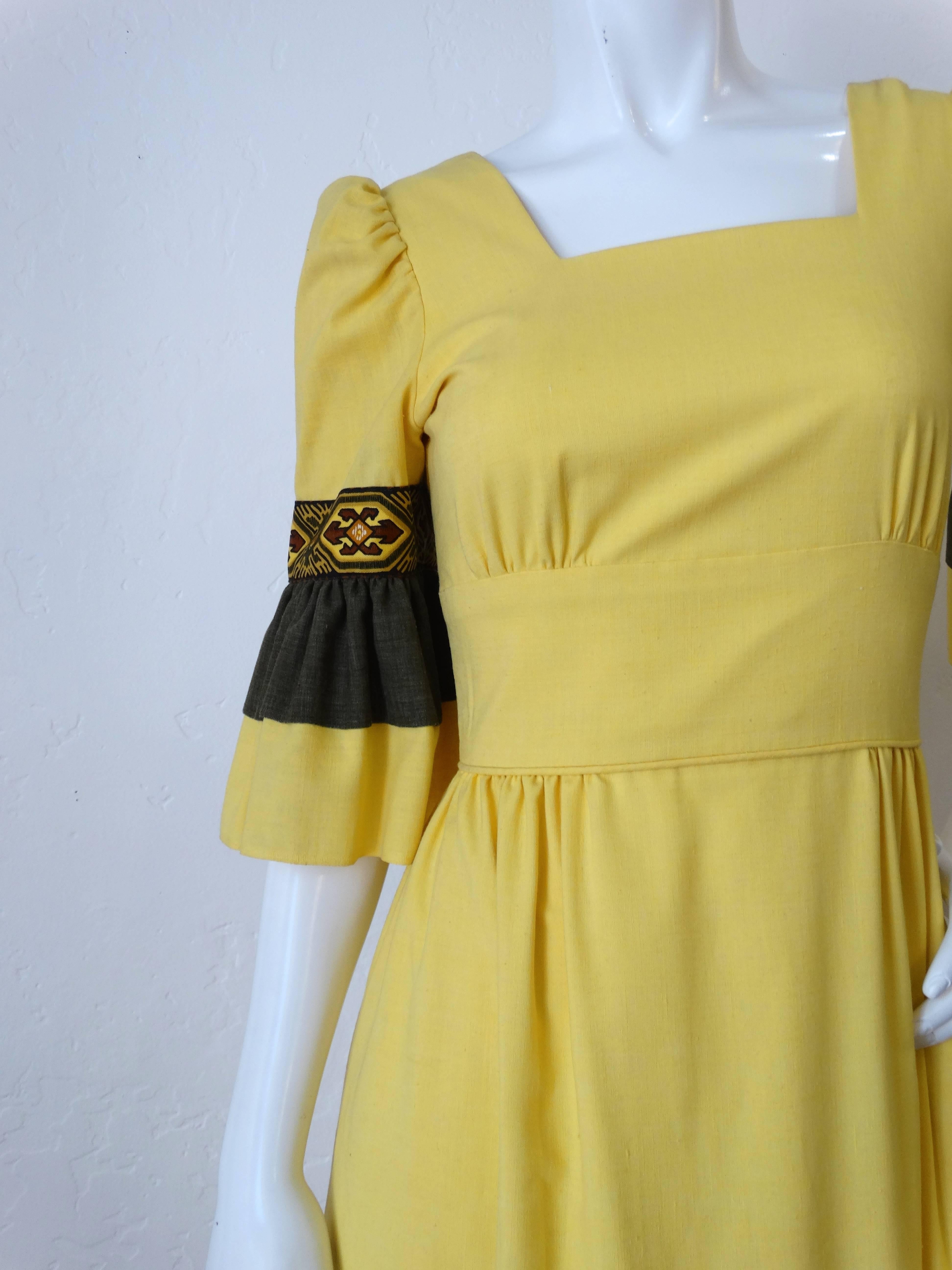 Early 1970s Handmade Southwestern Prairie dress! Flattering empire waistline with square neckline. Tiered skirt with black panel and geometric trim. Layered bell sleeves with matching trim. Zips up the back. “An Original By Kathy Henry” tag. Made in