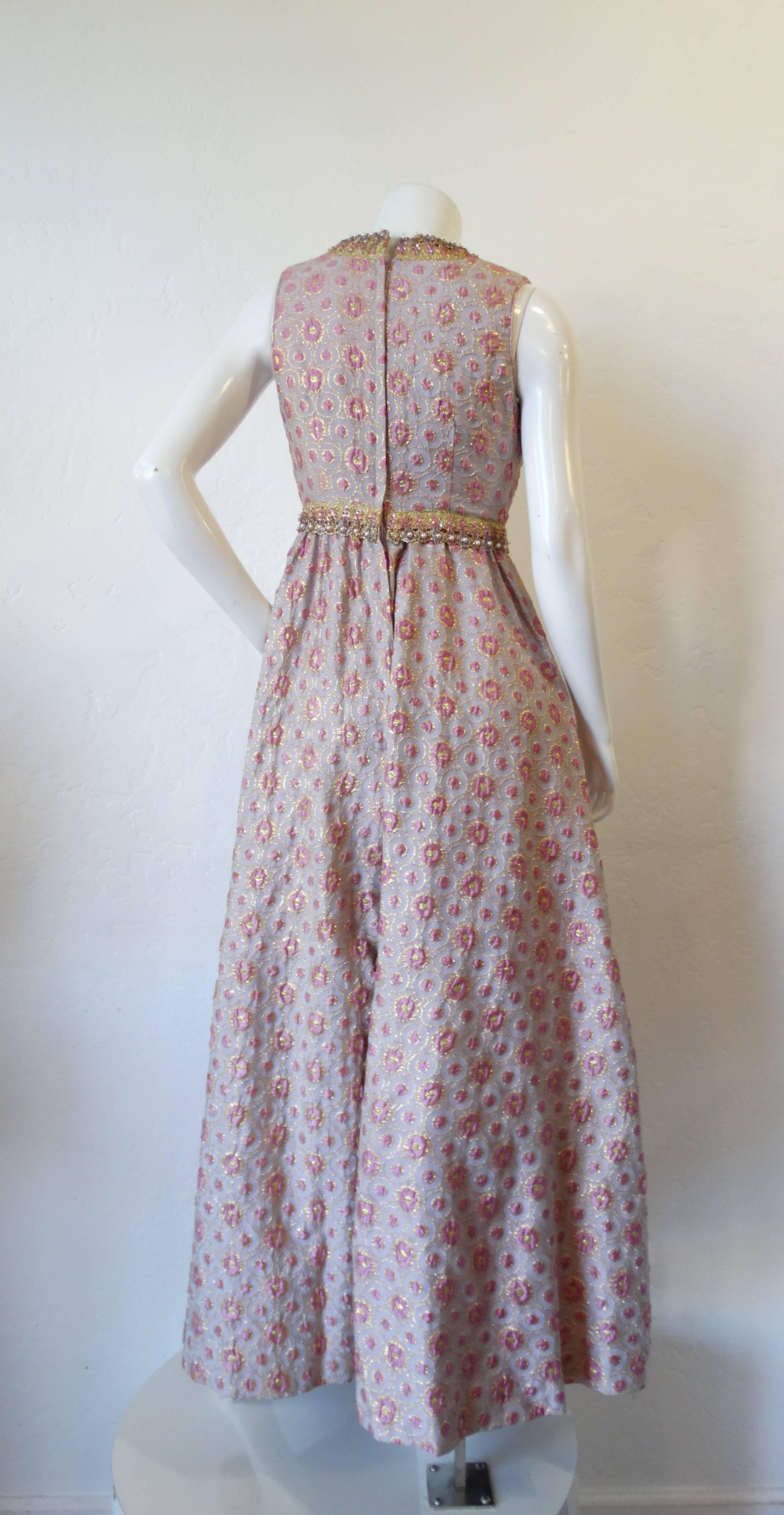The most elegant jumpsuit from the 1960s- designed by Sadie for I.Magnin. Sleevless fit with a v neckline. Unique pink and gold woven print accented with gold trim, faux pearl beads and sequins in matching hues of pink and lilac. Huge wide leg hem.
