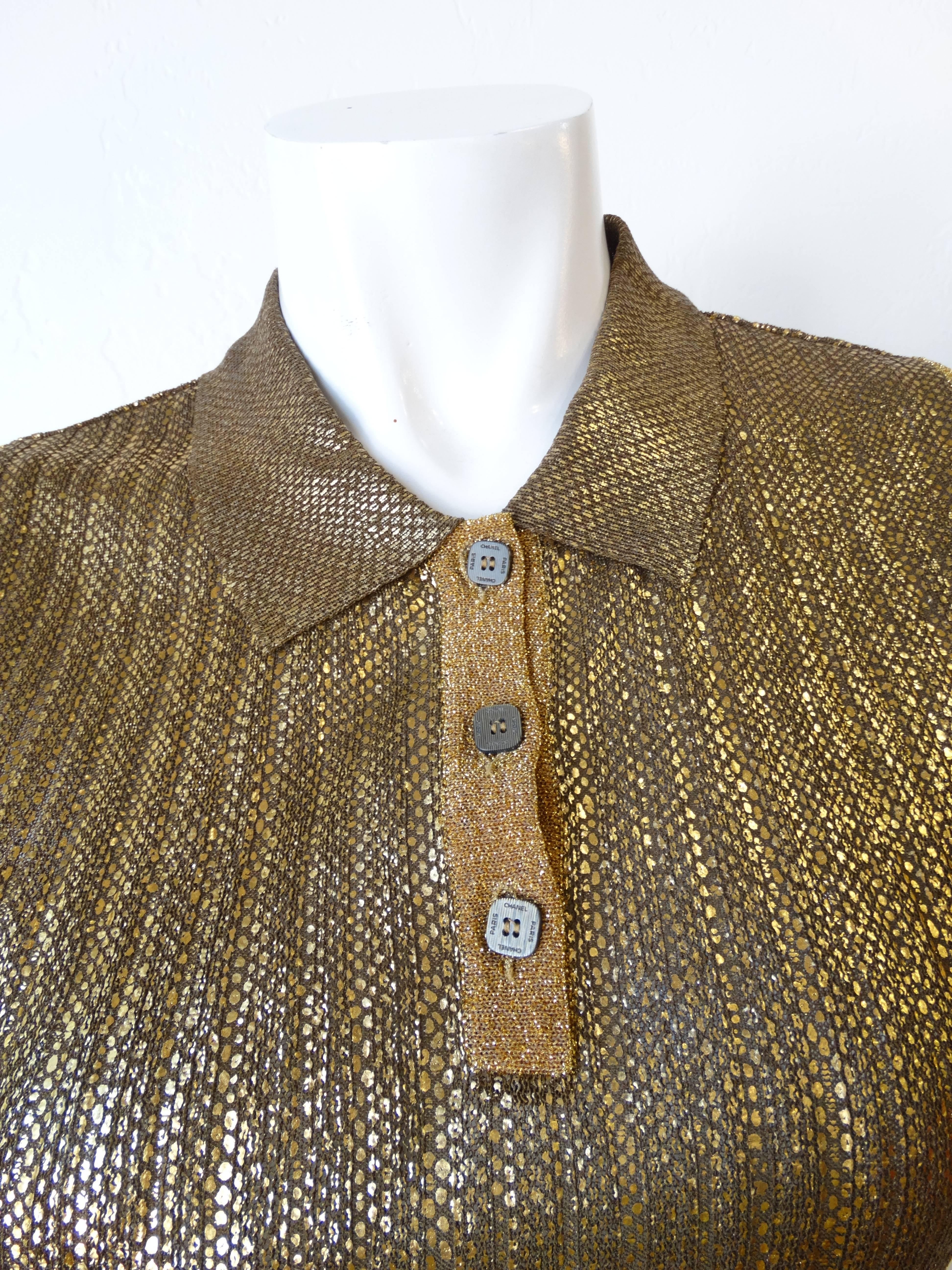 Super chic and shiny Chanel polo circa the 2000s! Knit semi-sheer fabric with gold and silver toned coating in a snakeskin like pattern. Gold lame knit trim beneath the buttons and along the arm holes. Three square buttons up the neckline with