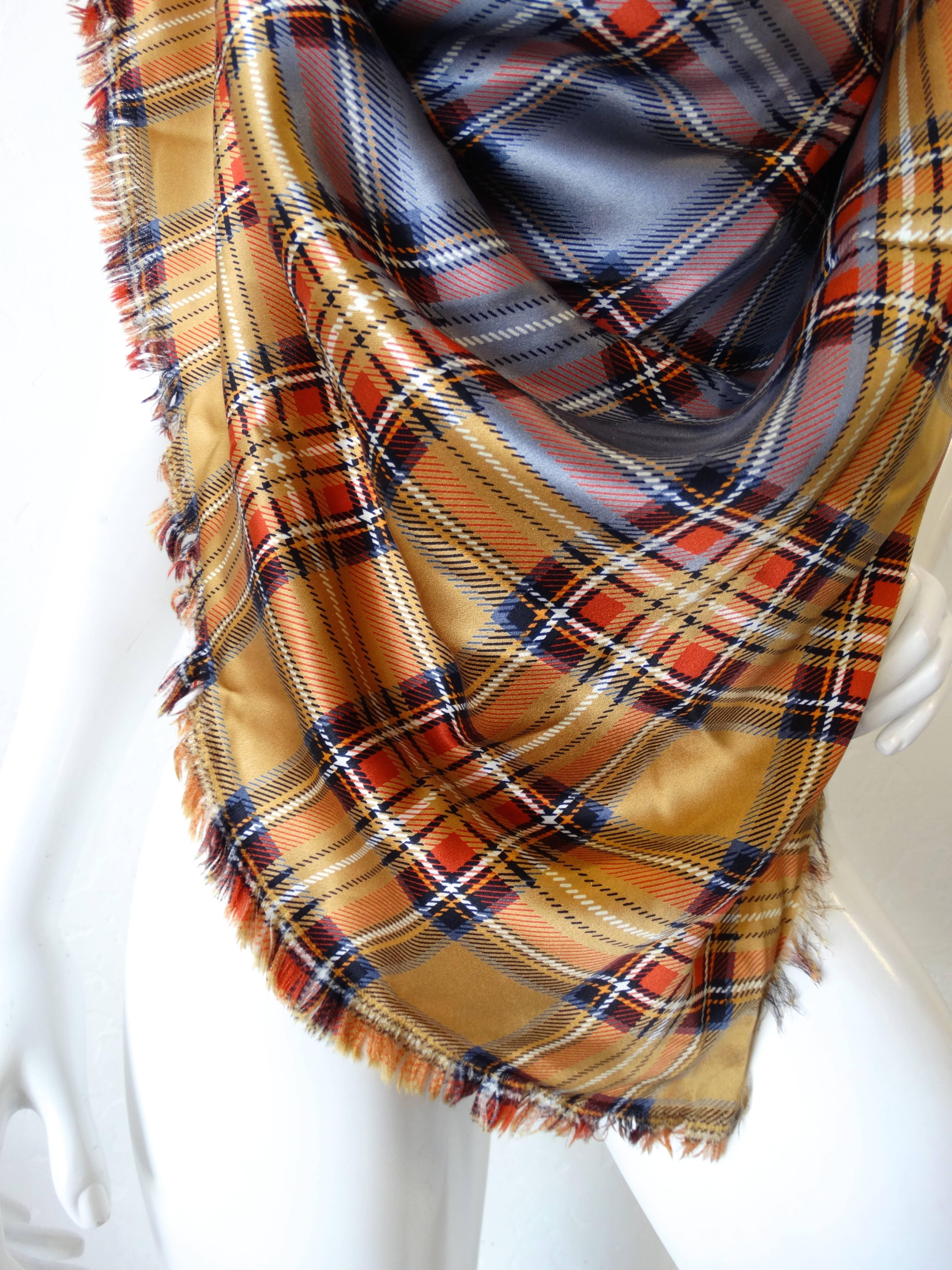 Amazing 1980s Yves Saint Laurent contrasting plaid scarf! Grey tartan plaid contrasted with tan plaid around the edges. Trimmed with frayed fringe all along the perimeter. This scarf is OVERSIZED and can be worn a number of ways. Shown here styled