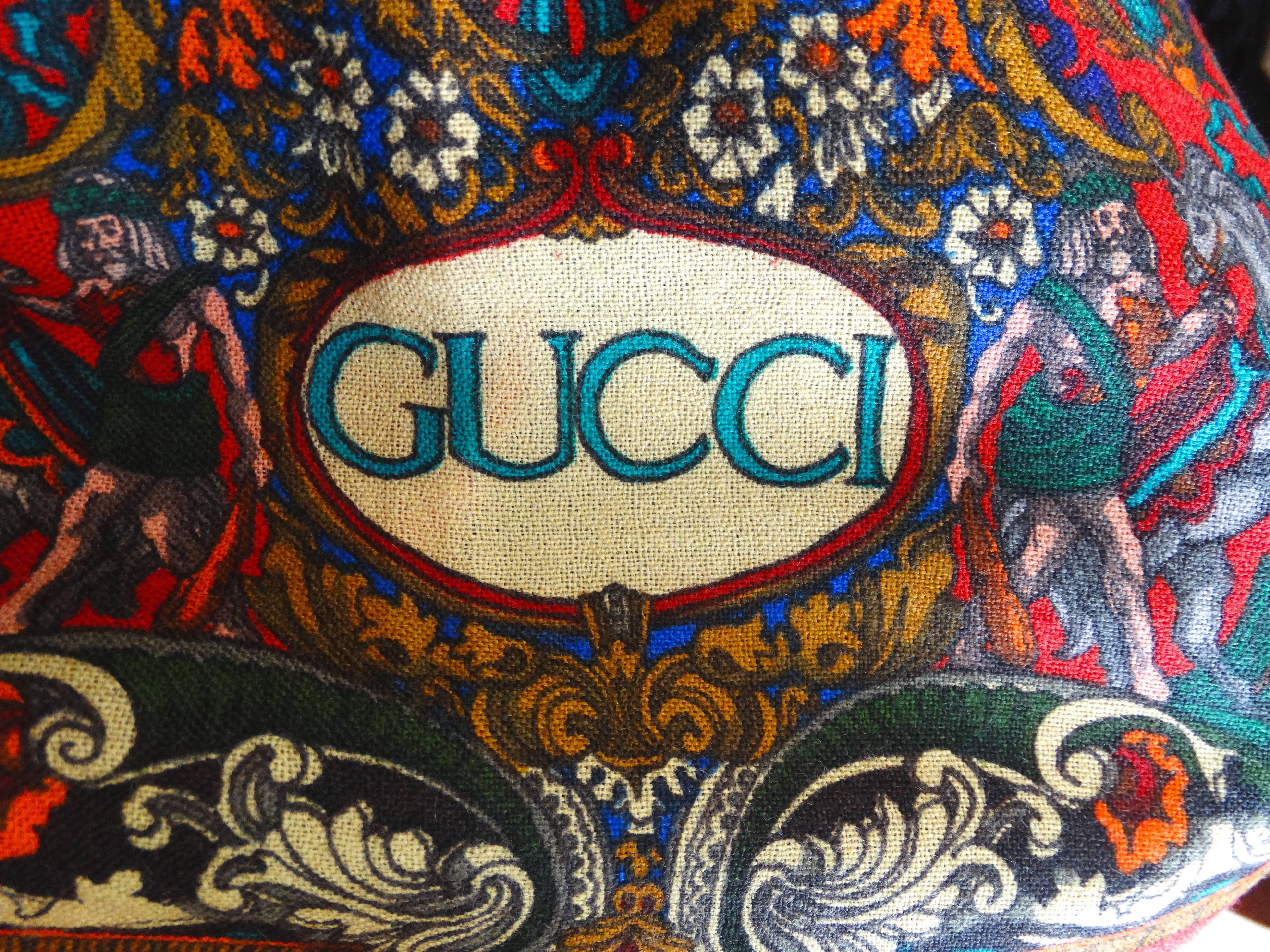 A wool shawl with a screen print style design, arabian horses with men of royalty in rich colors of red, cream, grey, turquoise to name a few. The GUCCI trademark symbol is the the original 80's logo, which Gucci has brought back and is one of the