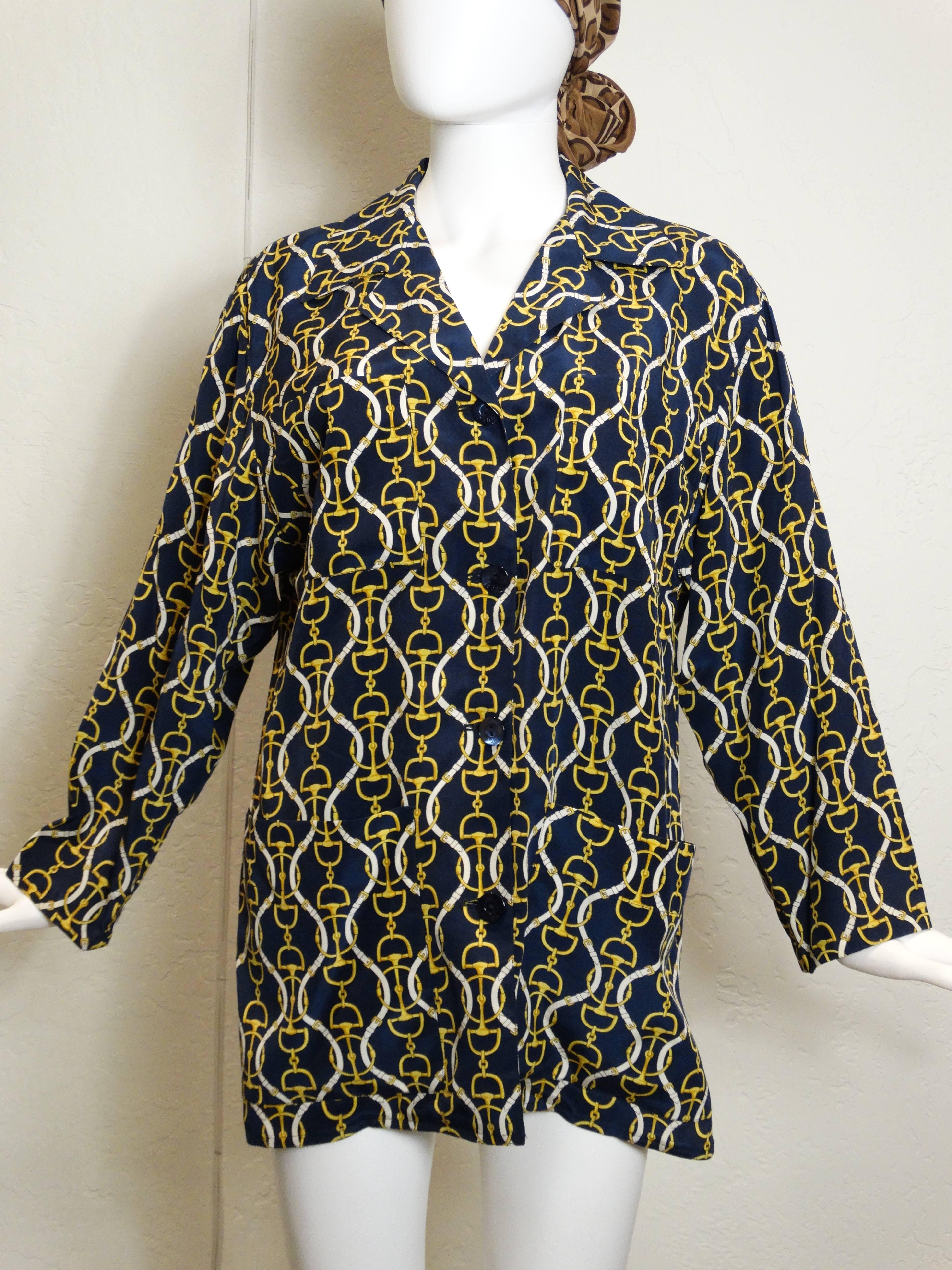 A fabulous silk 1980's Gucci jacket with the iconic horse bit print. The cut is a little boxy, but that was the 80's! This jacket has a top right pocket and two front bottom pockets. 4 large mother of pearl shell buttons with the iconic Gucci logo,