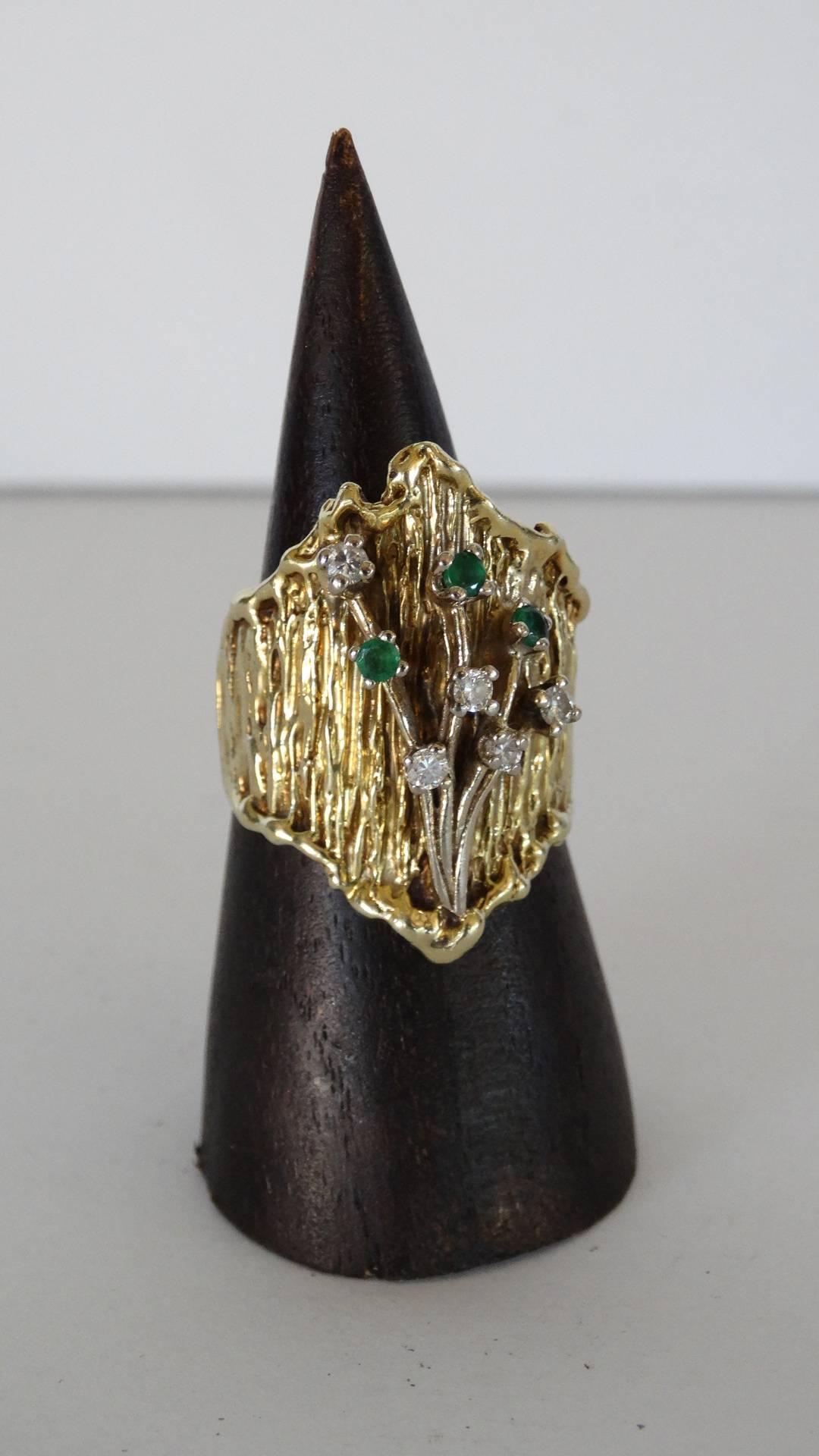 Beautiful 1970's custom made floral motif ring designed with 14 karat gold, 4 white diamonds .25 carat weight with 3 emeralds .15 carat weight. Ring weight is 16.89 grams. Ring Size 6 DM with any further questions. 