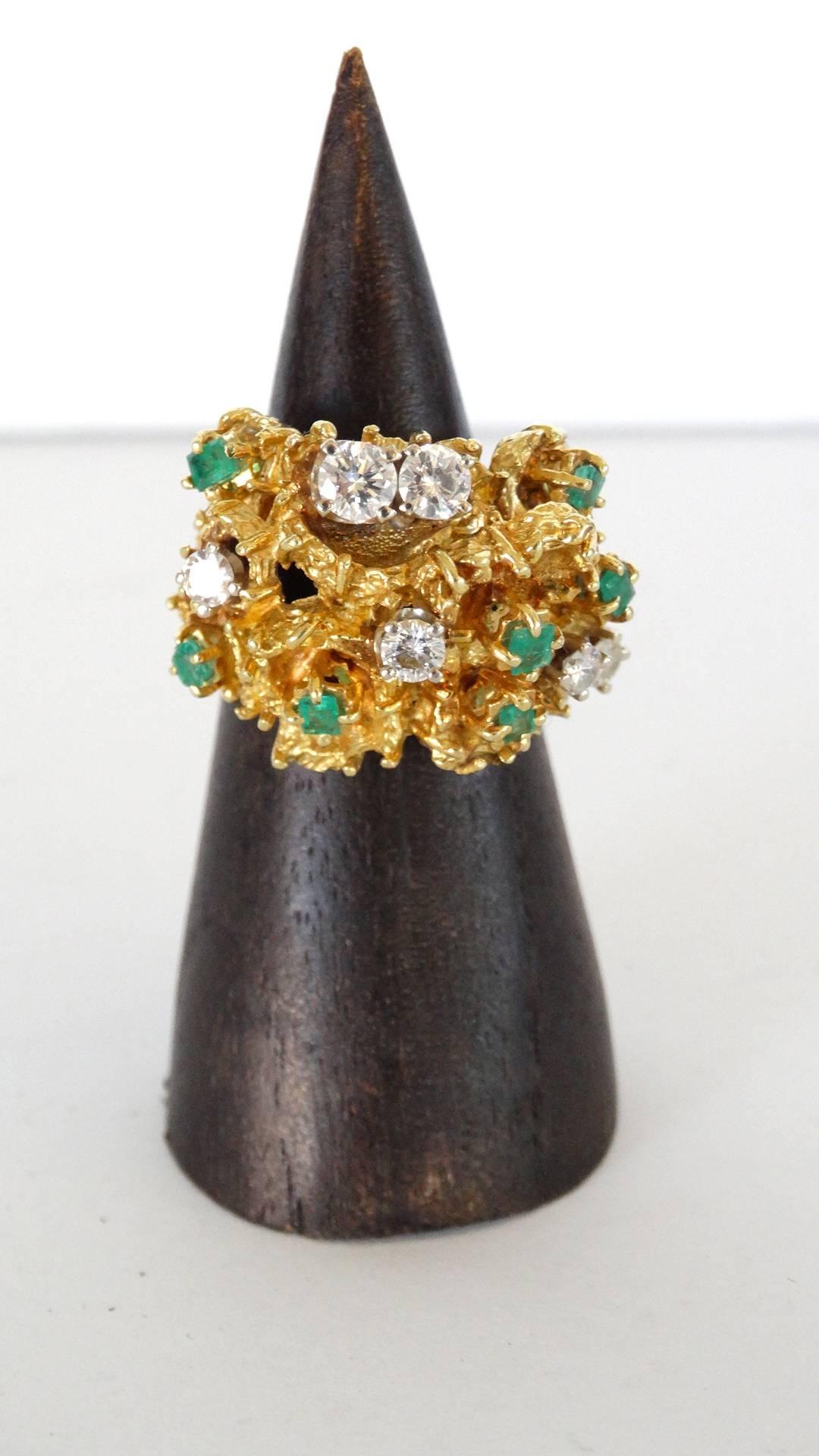 A beautifully designed 18 karat gold nugget ring with 6 white diamonds totaling to 1.2 carat and 6 emeralds totaling to 0.50 carat. This lovely cocktail rings weighs 20.98 grams. Size 6.5 DM if you have any further questions 