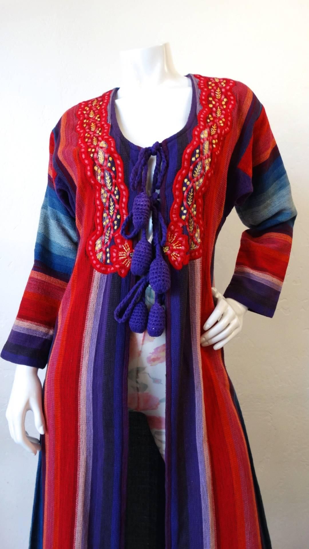 We're obsessed with Israeli designer Rikma- and you will be too with this amazing 1970s striped duster jacket! Made of a thick woven cotton in Rikma's signature striped pattern, in shades of red, purple and blue. Red scalloped embroidery all along