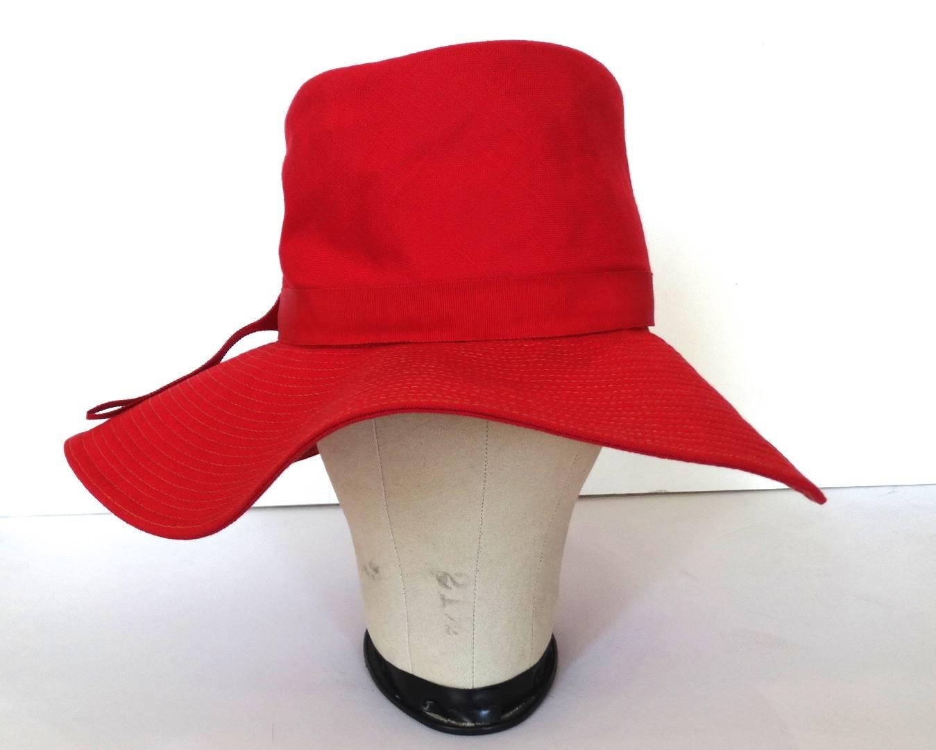 Your perfect summer hat has arrived with our red cotton & raffia hat! From The Paris Boutique, this eye-catching vintage hat is made of a thick red cotton fabric and brimmed with a red dyed woven raffia. Matching red cotton bow affixed at the base