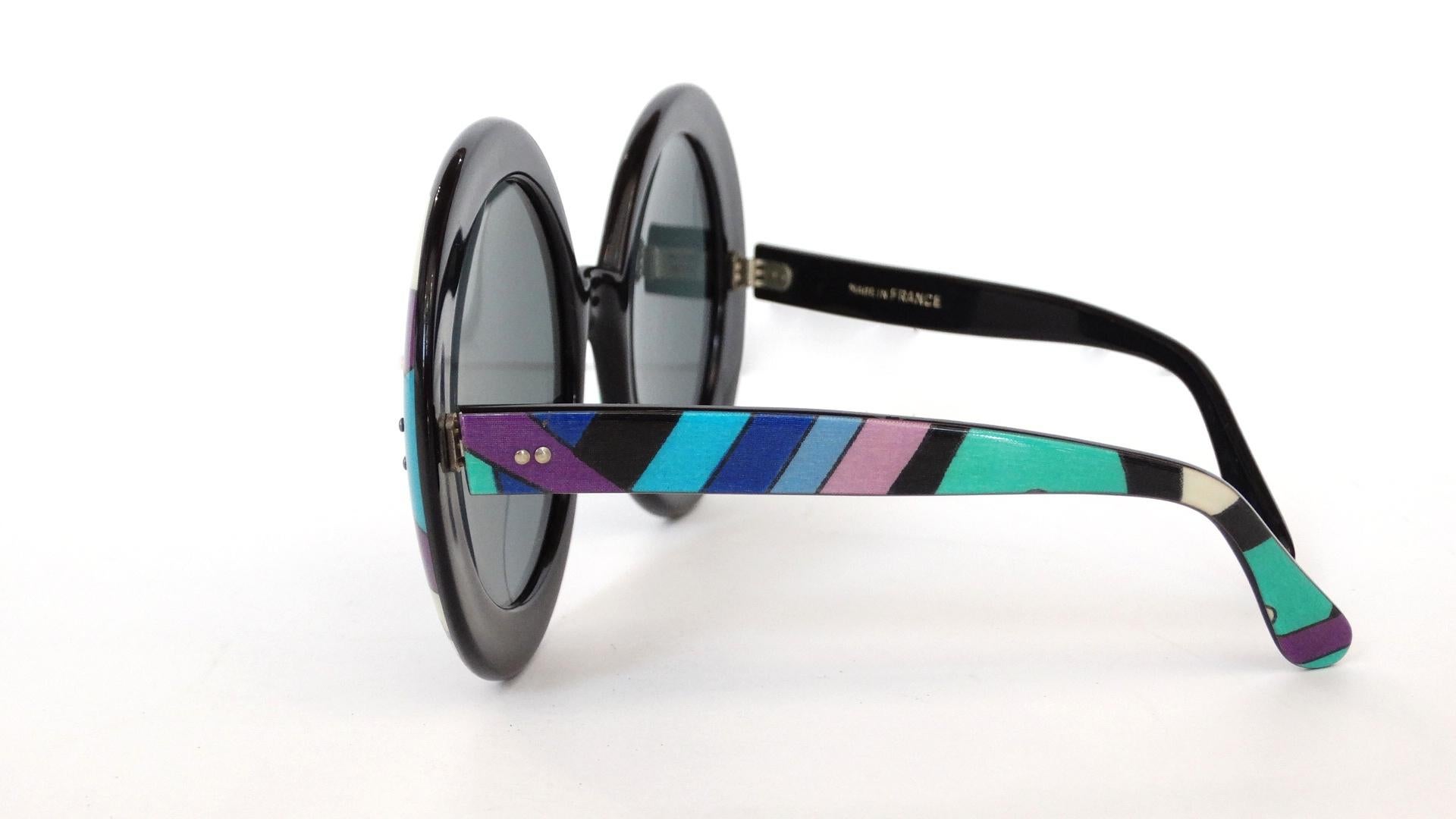 Channel your inner Iris Apfel with our incredible 1960s Pucci Sunglasses! These babies are OVERSIZED- the lenses measuring 3 inches across! Frames are solid black with rims of the signature Pucci swirl print around each of the lenses. Sepia tinted