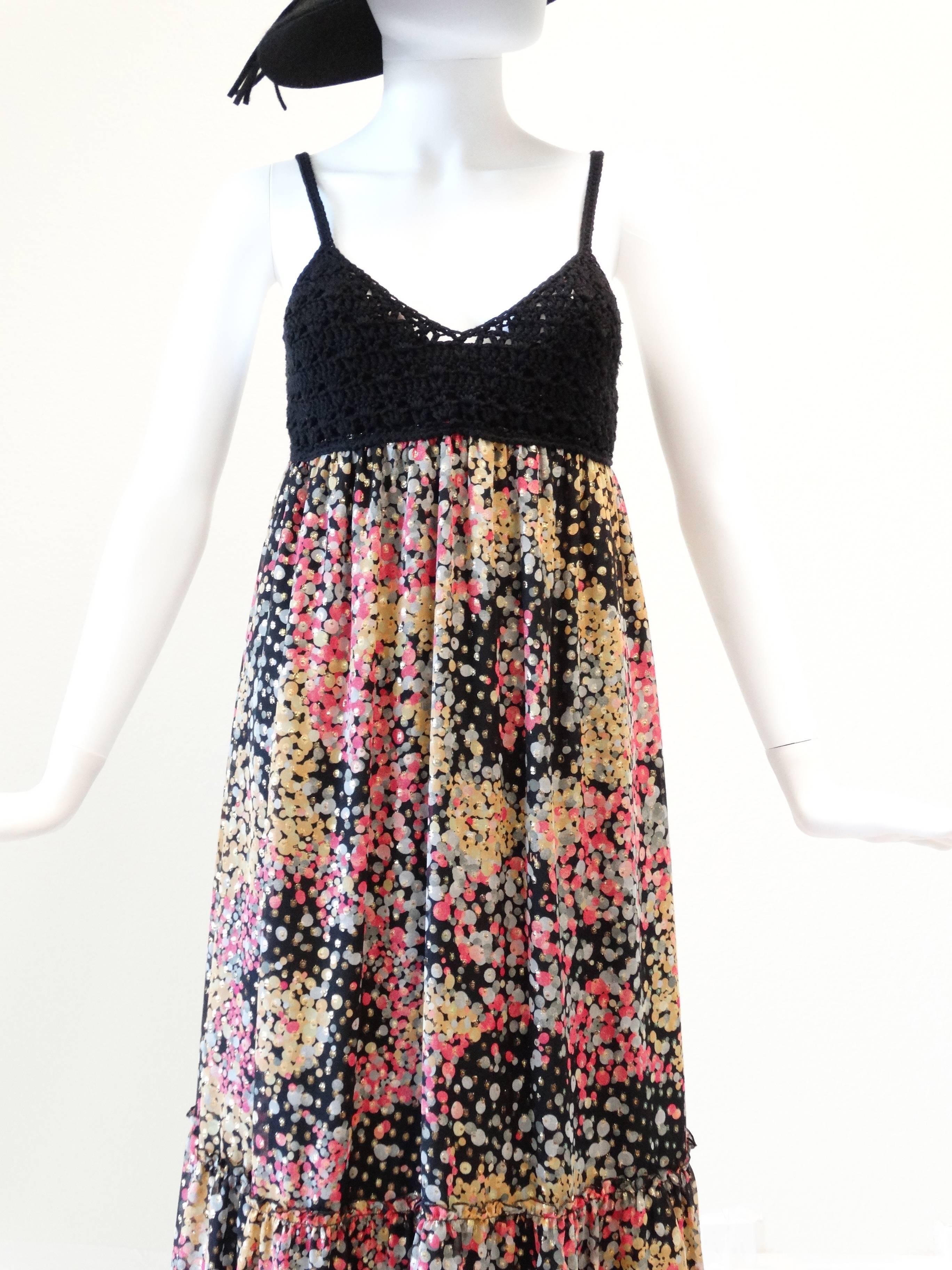 If you love Missoni this maxi is for you! Beautiful crochet top that ends under the bust. Maxi is empire waist with a beautiful confetti print with gold lame through out. Lined in silk... Marked size small

Measurements:

Bust 32-34
Waist 27
