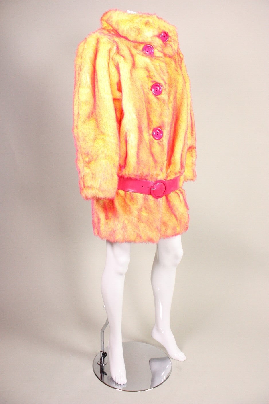 Thierry Mugler statement coat likely dates to the early 1990's.  It is made of pink and yellow faux fur with large plastic pink buttons.  Vinyl belt at hips.  Fully lined.

Labeled size 40.

Measurements-
Bust: 48