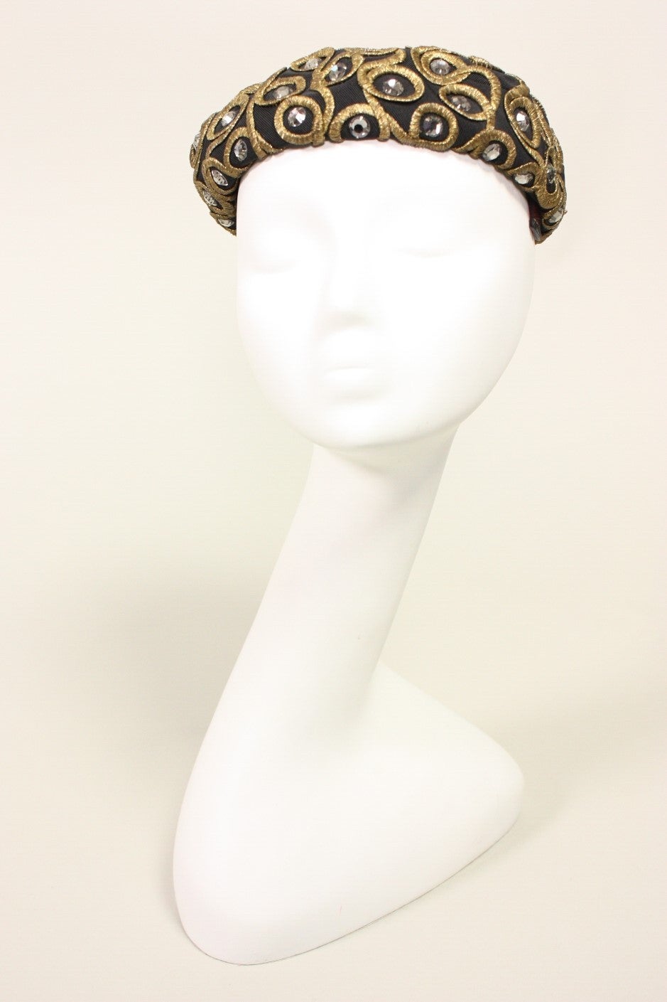 Black faille beret from Mr. John likely dates to the 1960's and is made of black faille with gold bullion and rhinestone ornamentation.

Interior Circumference: 21 1/2