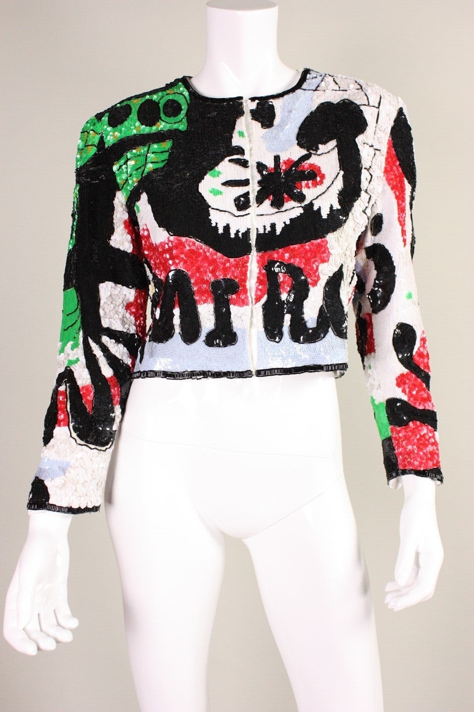 Unique jacket was made by Jeanette for St. Martin and retailed at Fred Hayman of Beverly Hills, CA.  It is fully covered with sequins and beading with a graphic pattern reminiscent of Joan Miro's abstract paintings.  Center front covered snap