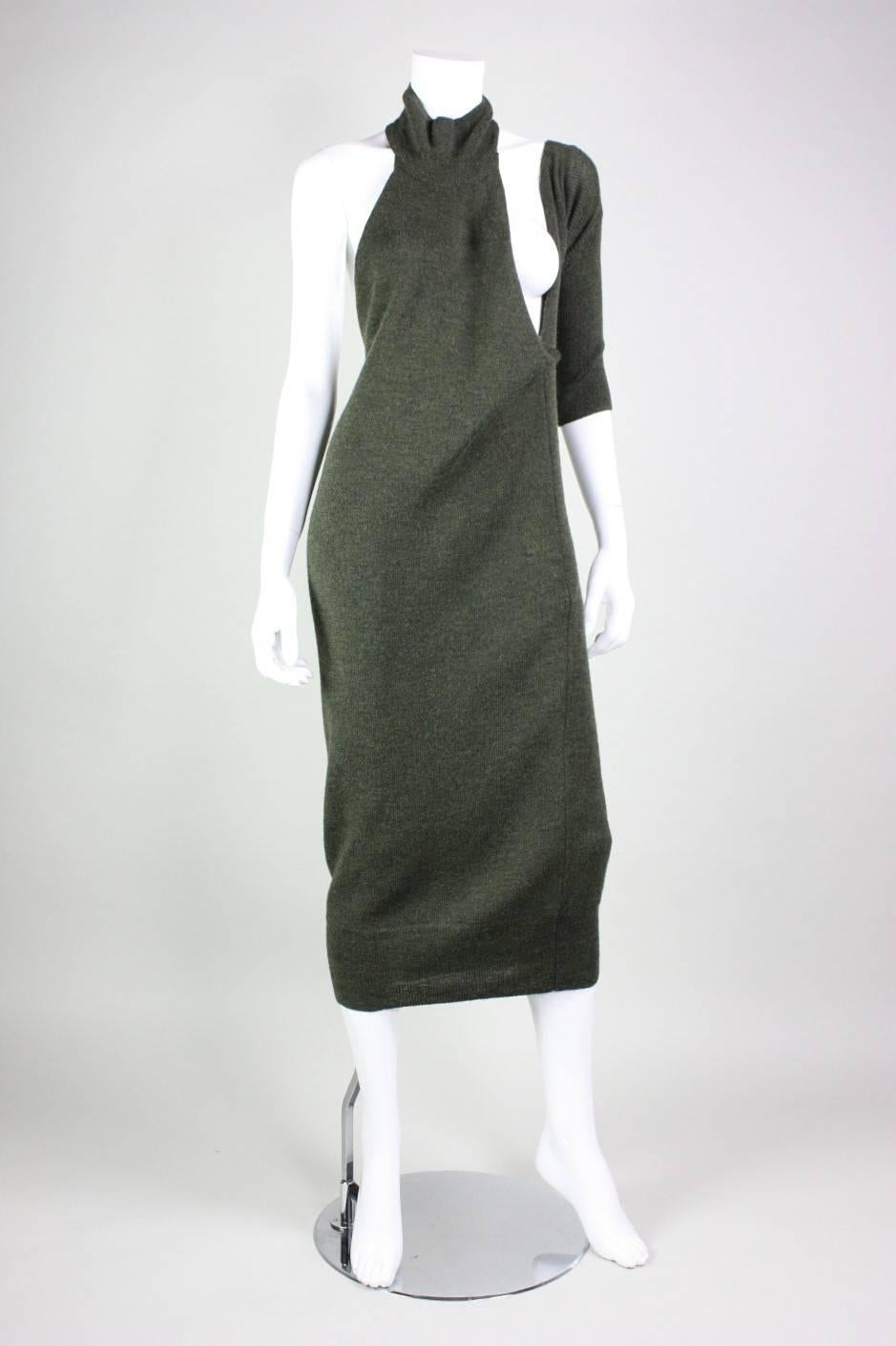 Unusual sweater dress from Yohji Yamamoto is made of a muted green wool.  It features one sleeve, and exposed breast, and open back.  Tie at low center back.  No other closures.  Unlined.

Labeled size Small.

Measurements-
Bust: Open
Waist: