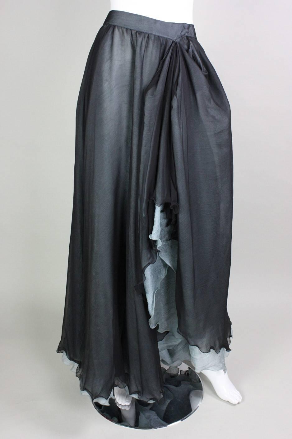 Vintage skirt from Giorgio Armani likely dates to the 1990's and is made of two layers of silk.  Under layer is a baby blue silk jacquard with a floral pattern.  Over layer appears to be black silk organza.  Side front of skirt has been stitched at