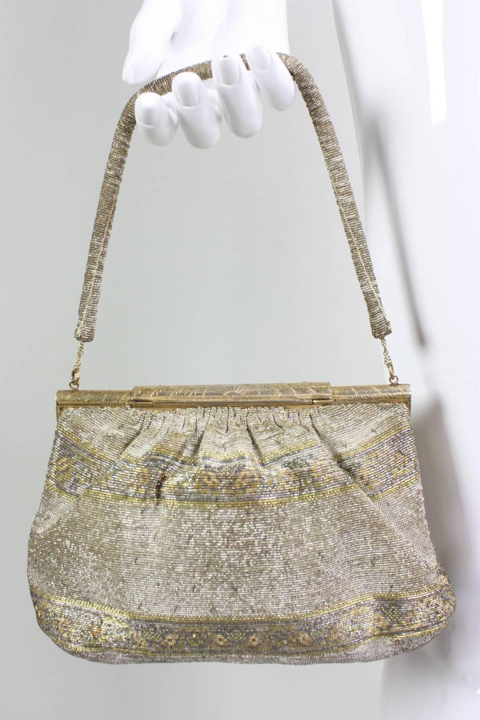 "Hand made in France".  Etched gold-toned frame and clasp with marcasite.   Tan satin lining with side pockets.

Measurements-

Top Width: 7 1/4"
Bottom Width: 9"
Height: 6 1/4"
Strap Drop: 5 3/4"