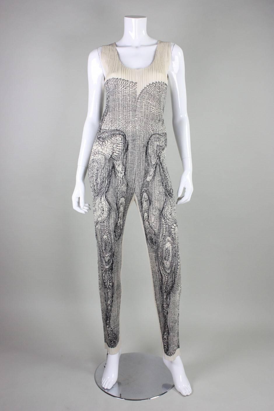 Issey Miyake Artist Series No. 3- Tim Hawkinson is made of cream pleated polyester.  No closures.  Unlined.  New with tags.
Labeled a size 4, but please refer to measurements as it would fit a wide variety of sizes. Jumpsuit was not pinned on