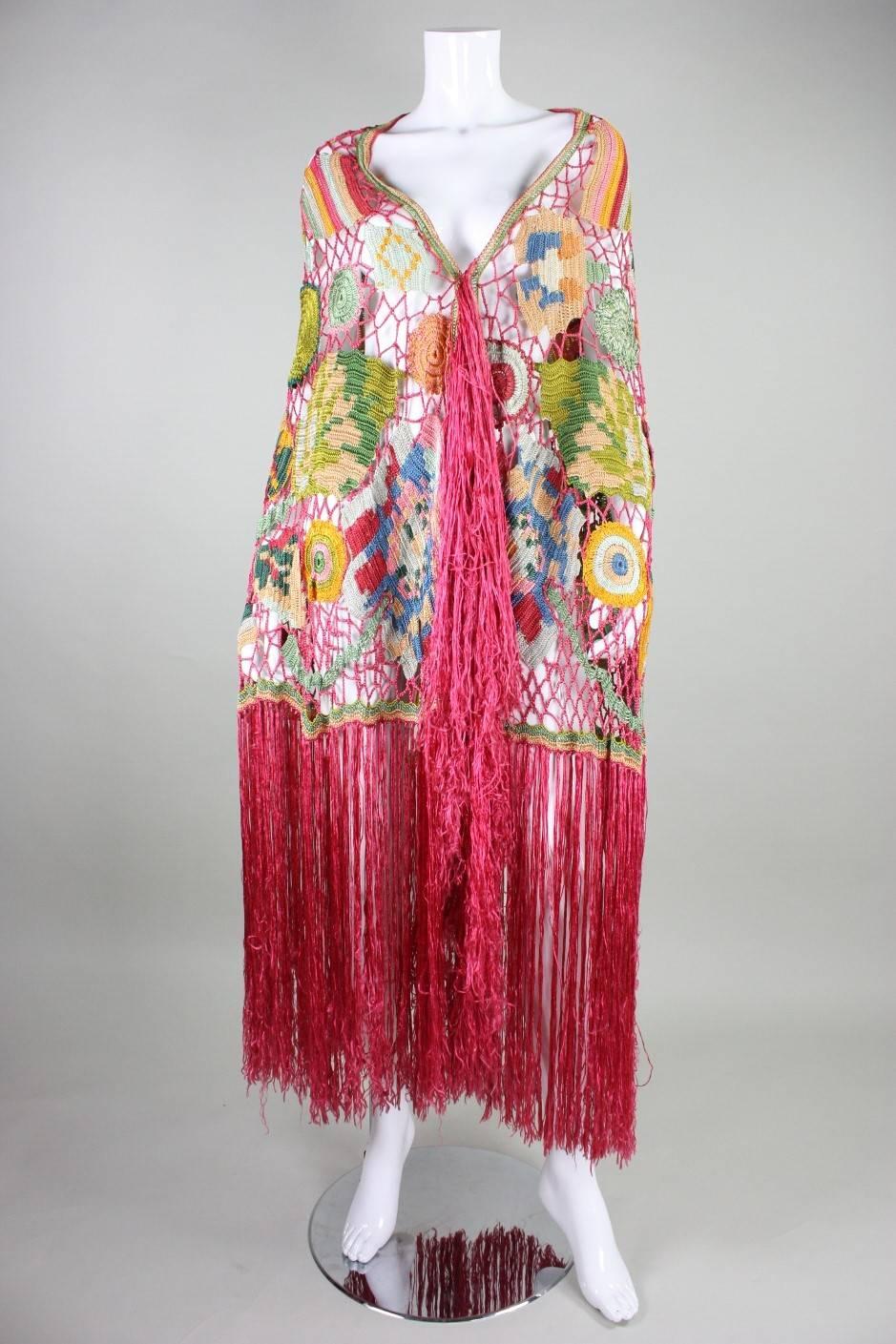Vintage shawl dates to the 1920's and is made of a polychromatic blend of bright rayon.  Abstract floral motif contains birds in the design, and although the design is not symmetrical, there is a balance of color and weight that exists within the