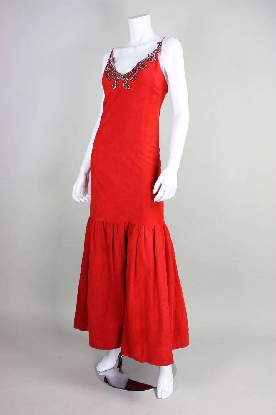 Stavropoulos gown dates to the 1980's and retailed at Martha's. It is made of cherry red suede and accented at the bodice with clear rhinestones and red beads. Center back zipper. Fully lined in a lightweight silk.

Measurements-
Bust: