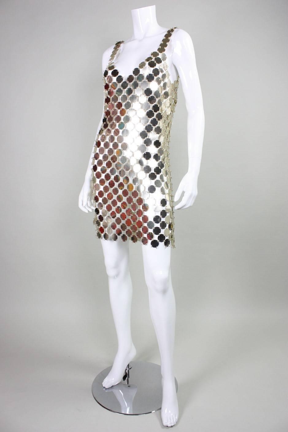 Vintage dress dates to 1996 and was made from a do it yourself dress kit by Paco Rabanne.  It is made entirely of silver-toned lightweight metal discs with gold-toned o-ring connectors.  No closures.  Unlined.

No size label, but it would fit a